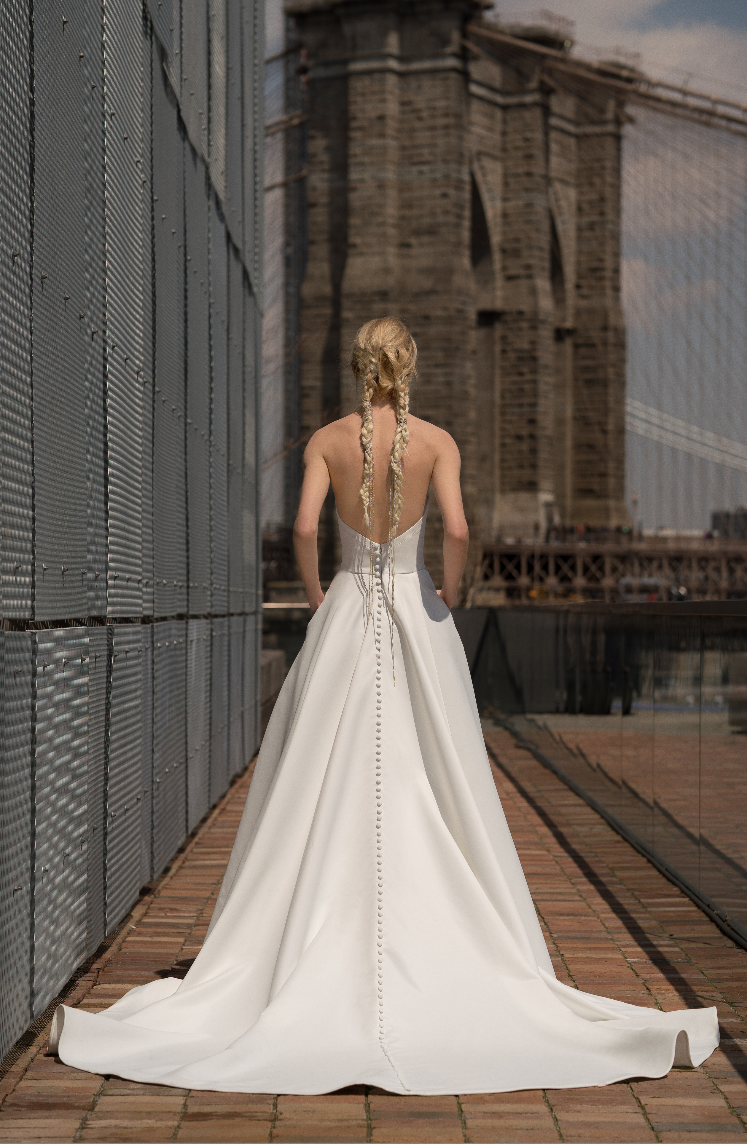Back view of Blanchett ivory matte satin A-line gown with full skirt and pockets.