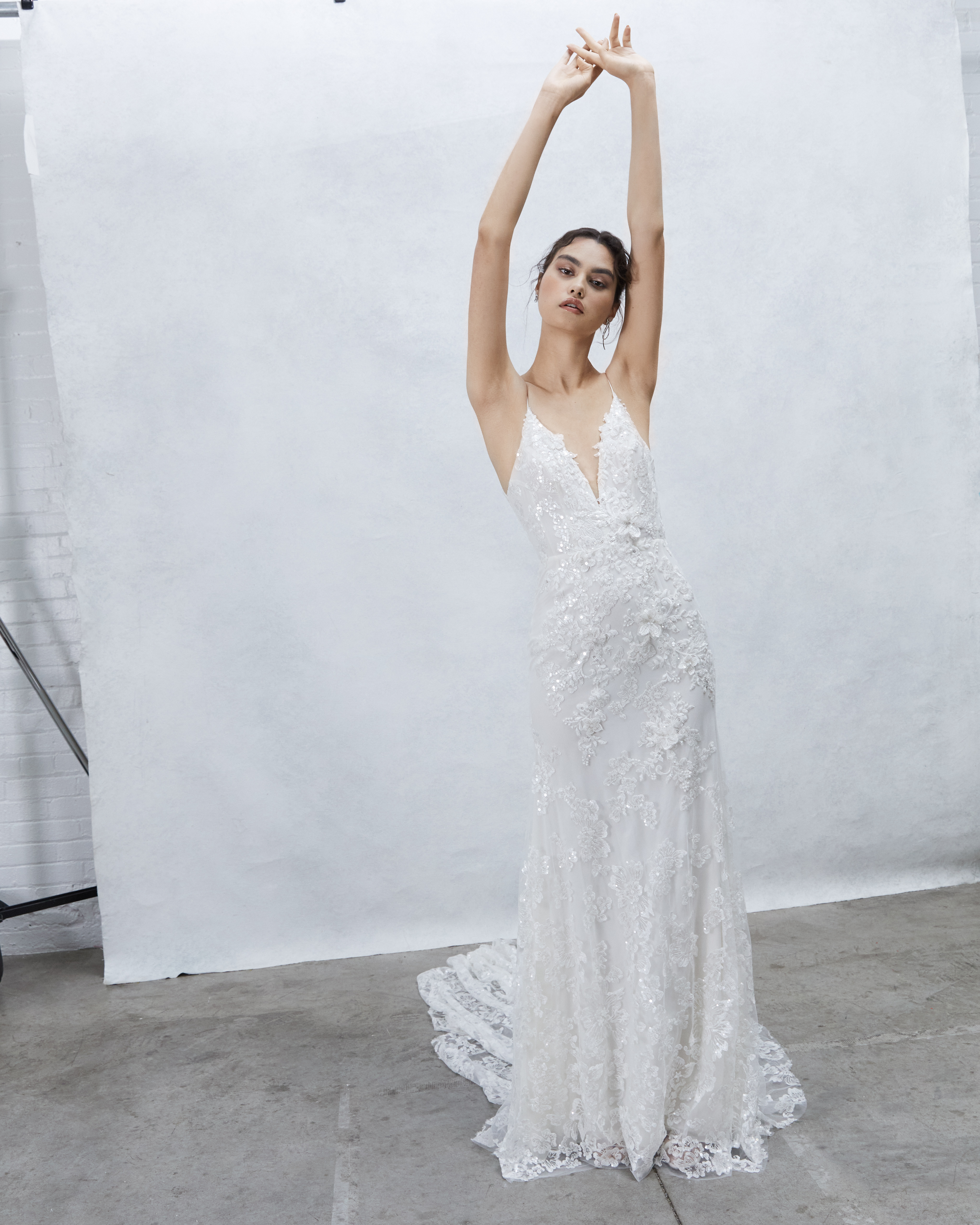 Nova embroidered lace sheath gown with deep V ballerina bodice and lace appliqué detail, shown from the front.