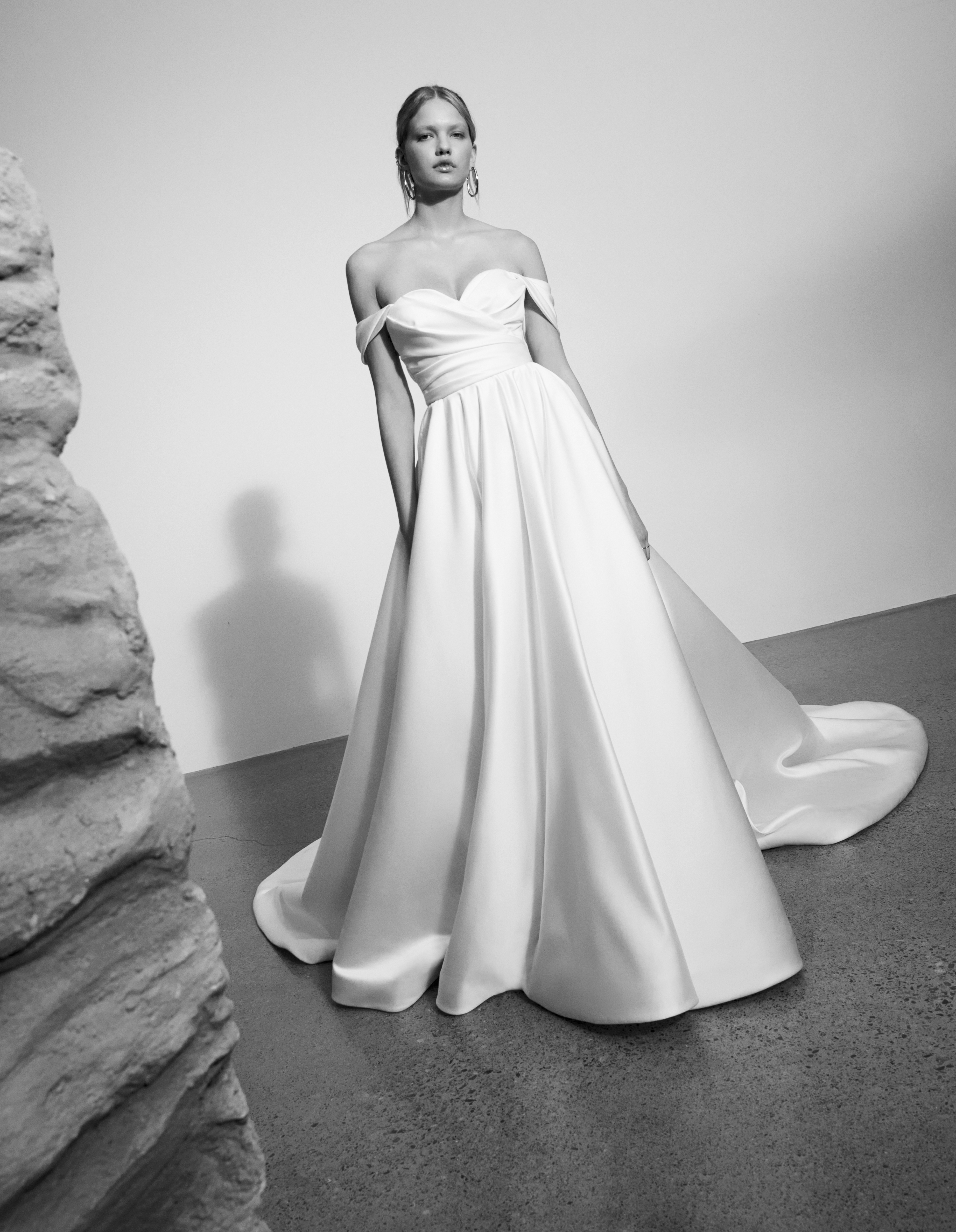 Mackenzie satin off-the-shoulder ball gown with draped bodice and full skirt, shown from the front.