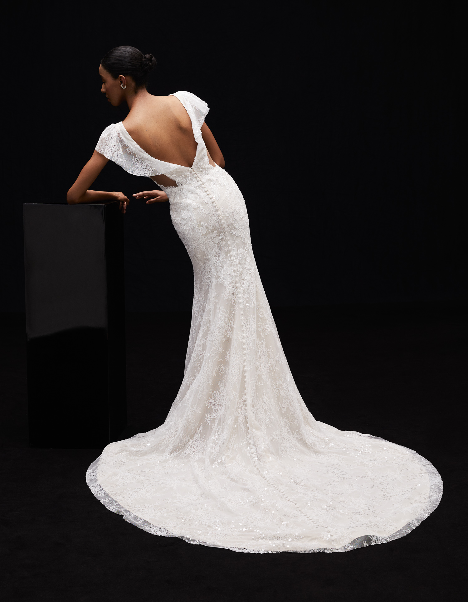 Side view of Juliette embroidered shimmer lace sheath gown with flutter sleeves and hand-applied floral lace train.