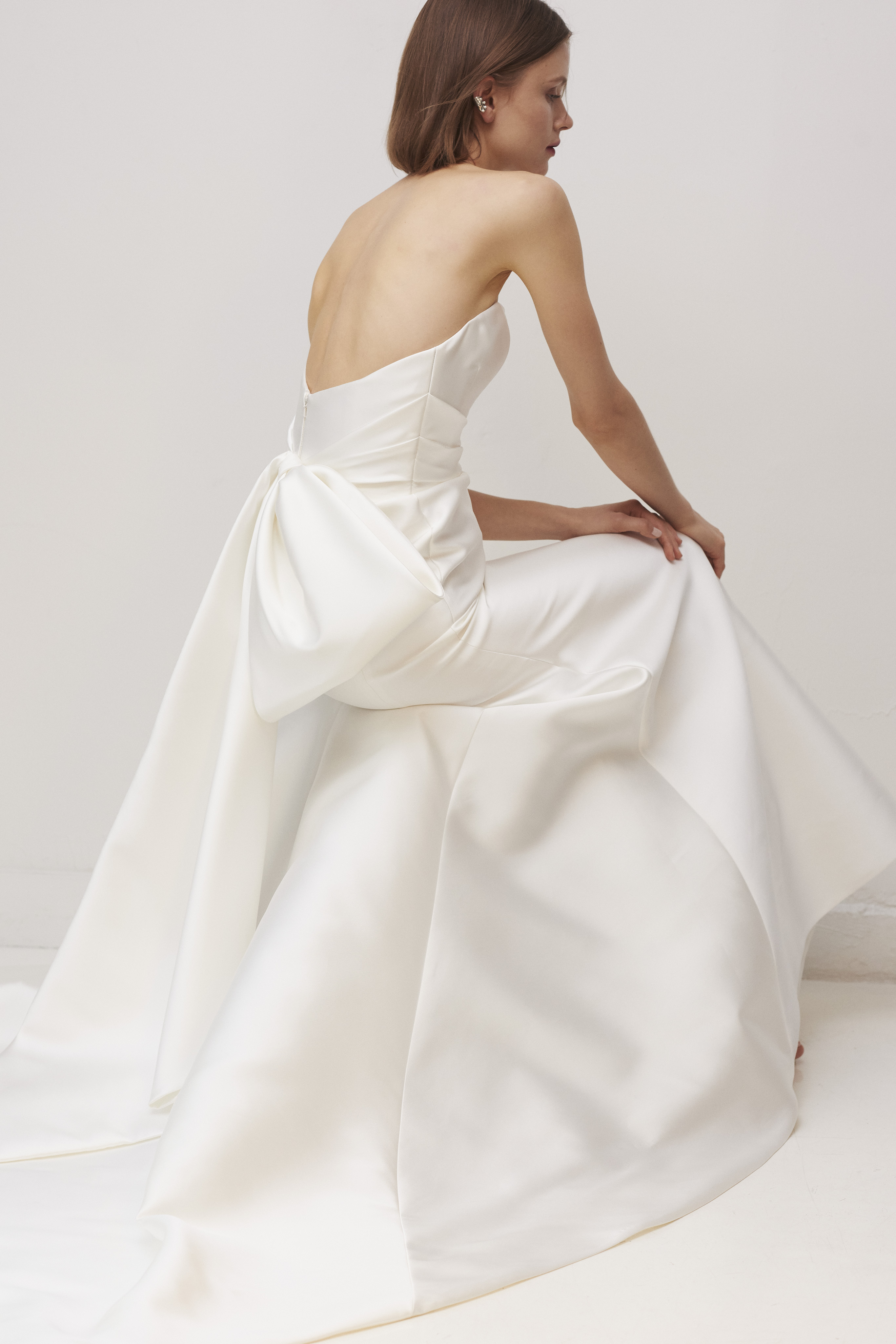 Back view of the Oxford gown, showing the regal draped bow detail and soft train.