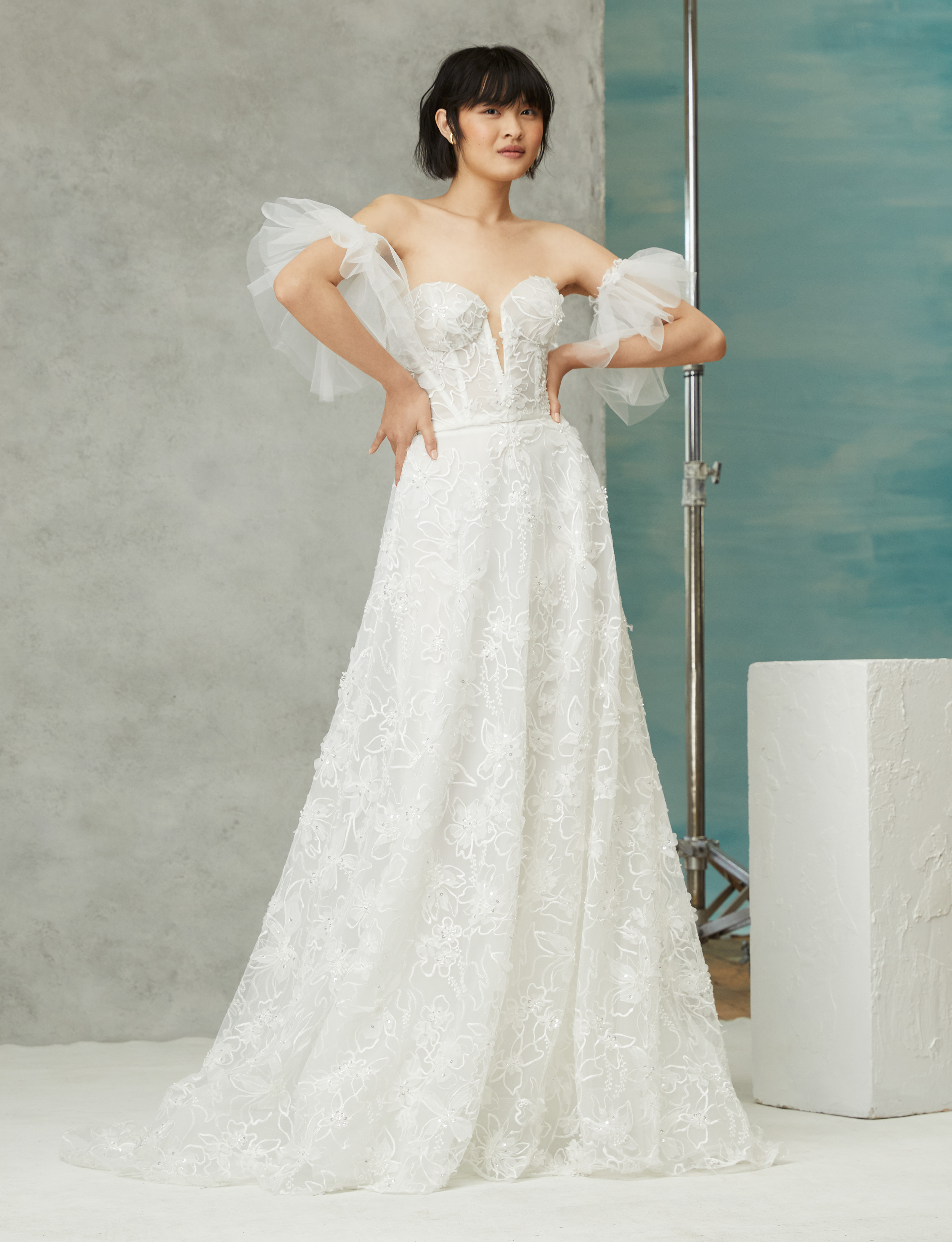 Belle ivory ball gown with corset bodice, 3D beaded floral lace, and detachable tulle flutter sleeves, shown from the front.
