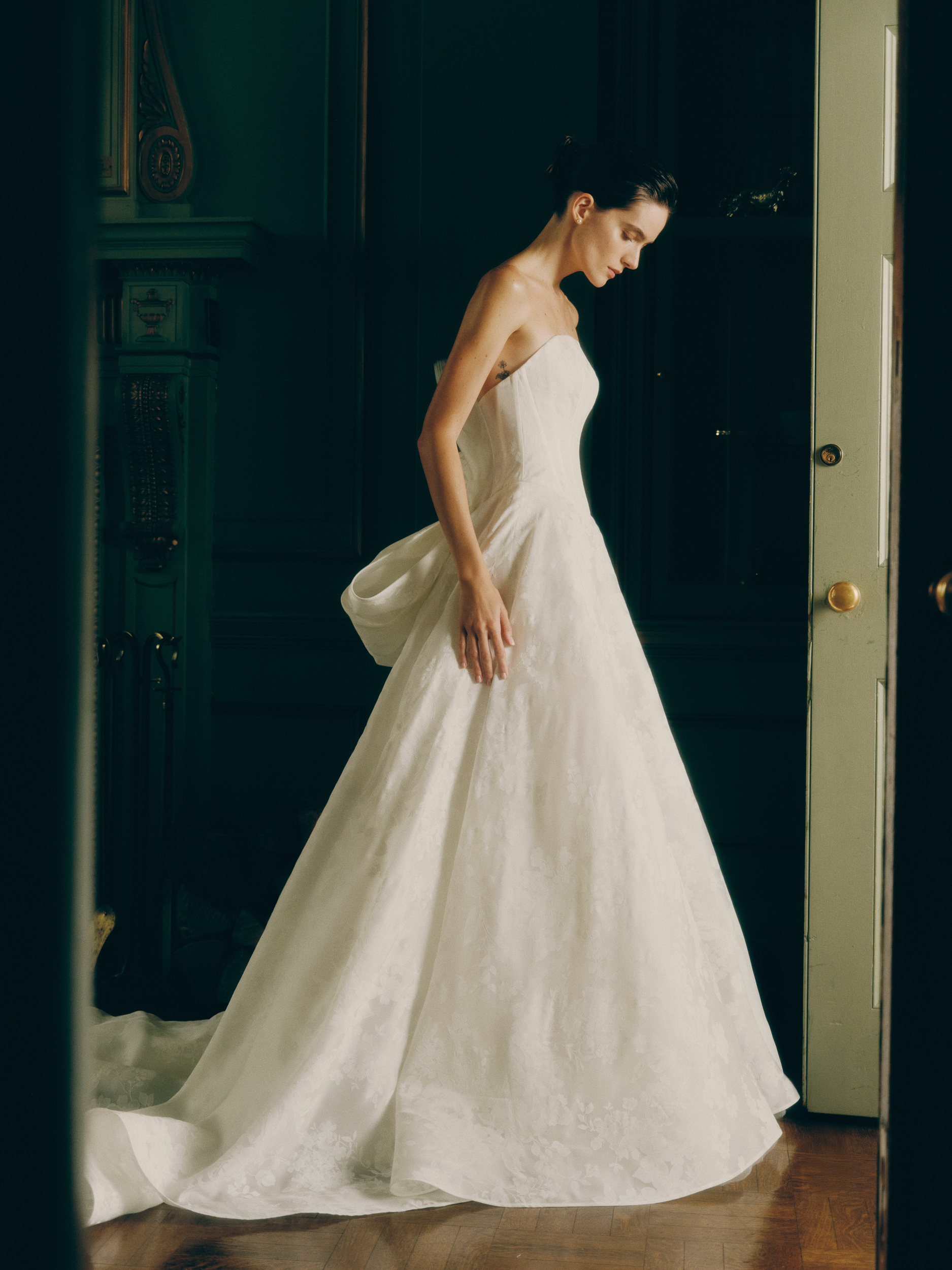 Side view of the Issie ballgown, showing the painted silk satin organza skirt and full train.