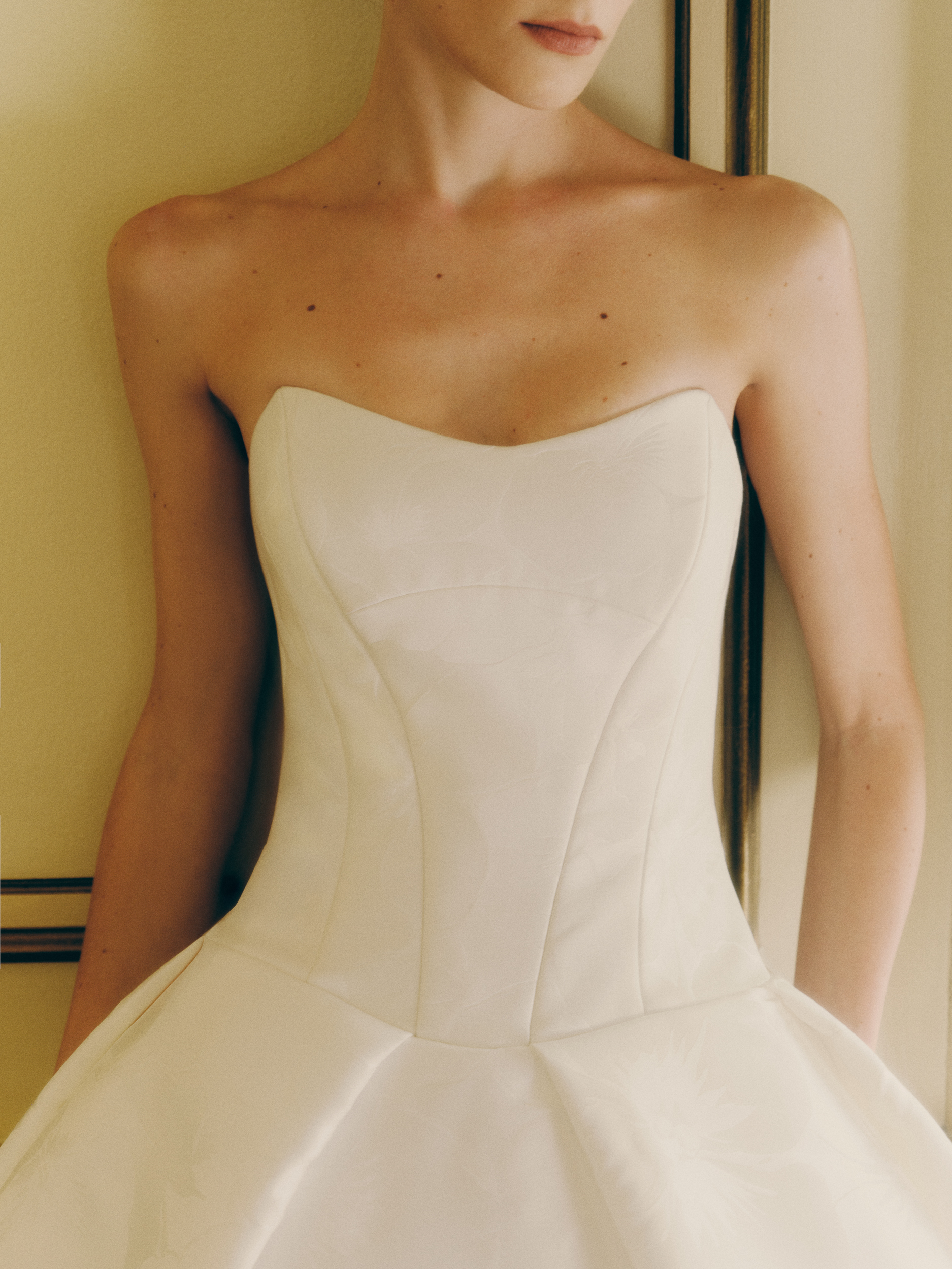 Close-up of the Yates ballgown, showing the cat-eye neckline and architectural bodice detail.