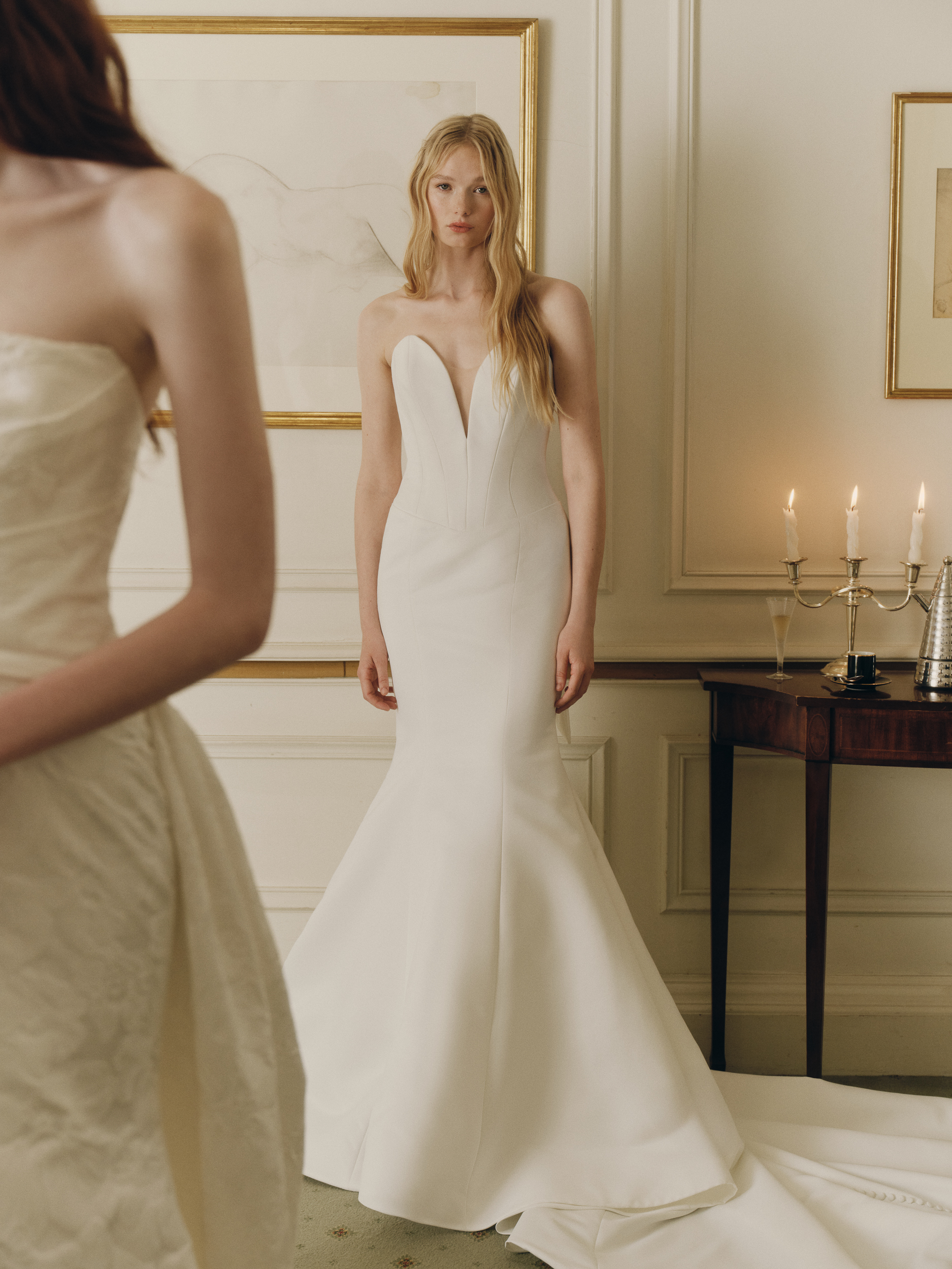 Front view of the Norra fit-and-flare gown, showing the basque waist, buttons to hem, and architectural single-loop bow.