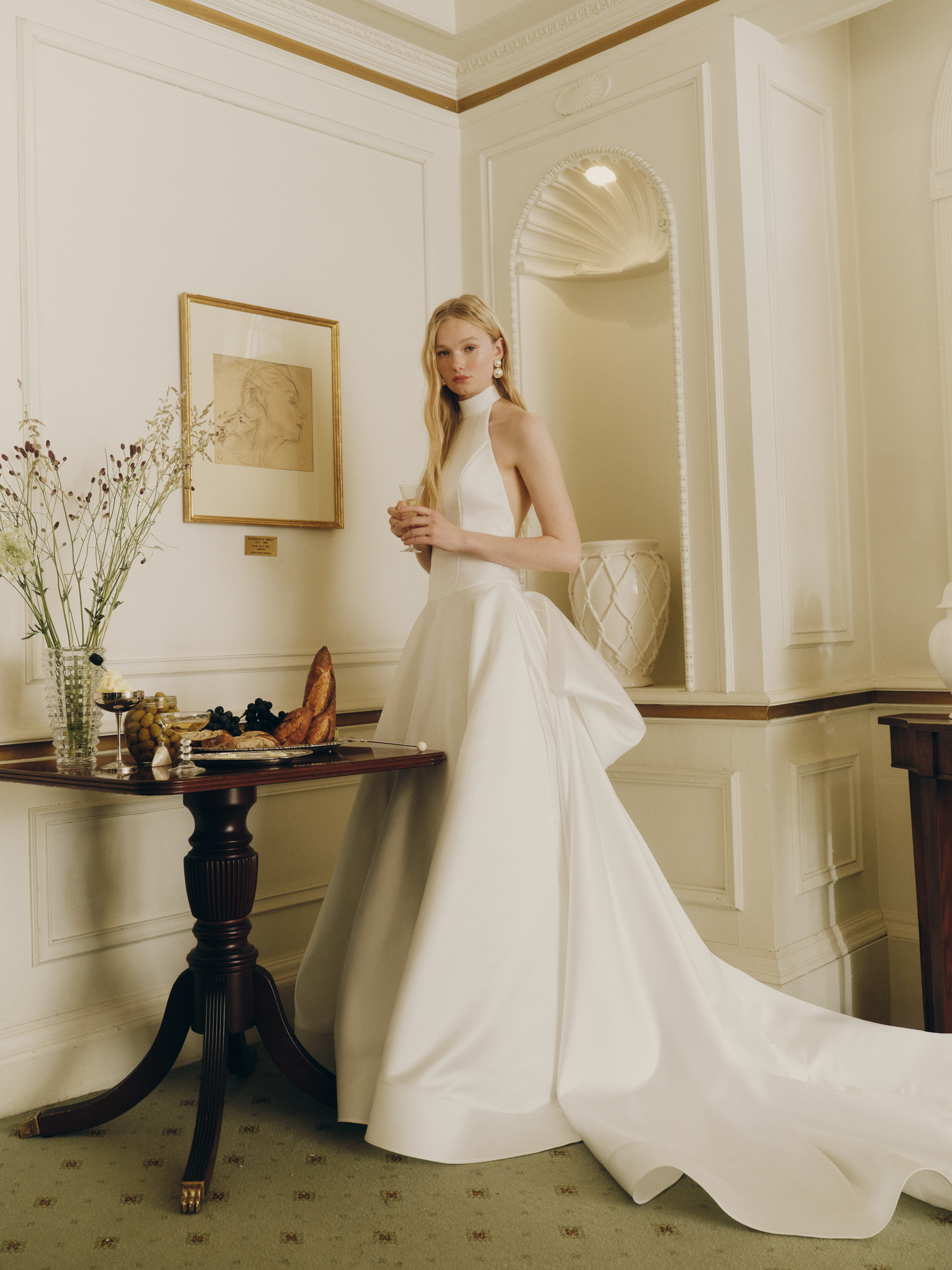 Bride wearing the Pippa ballgown with mock neckline, full skirt, and dramatic bow at the back.