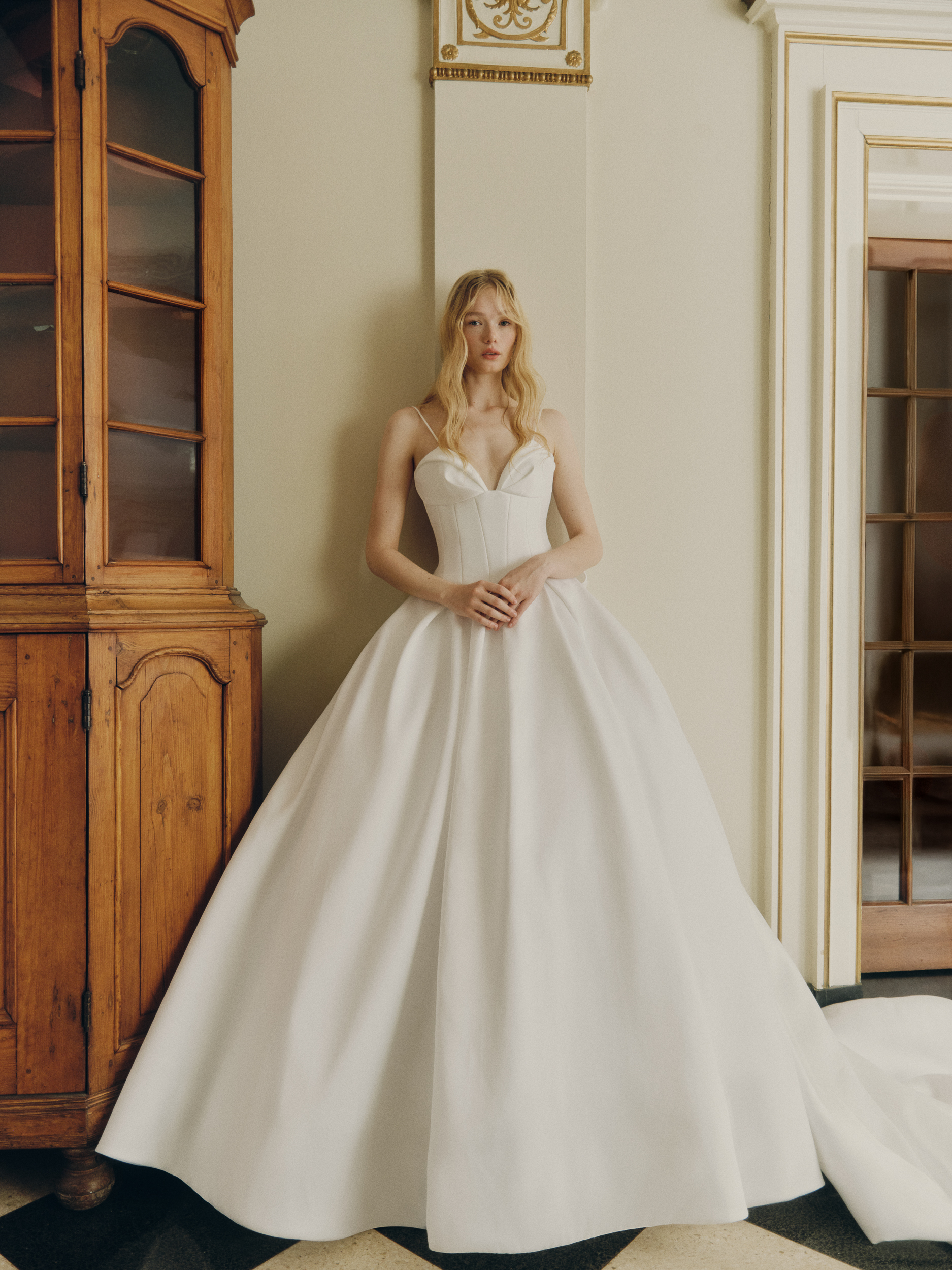 Full-length view of the Clovie drop-waist ballgown with draped corset, seam-detailed midriff, and full pleated skirt.