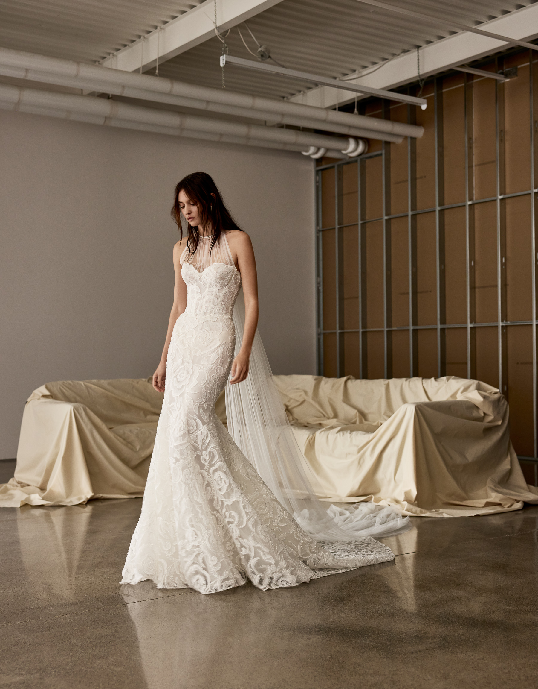 Side view of Cameron strapless fit-and-flare gown with detachable tulle gilet and watteau train.