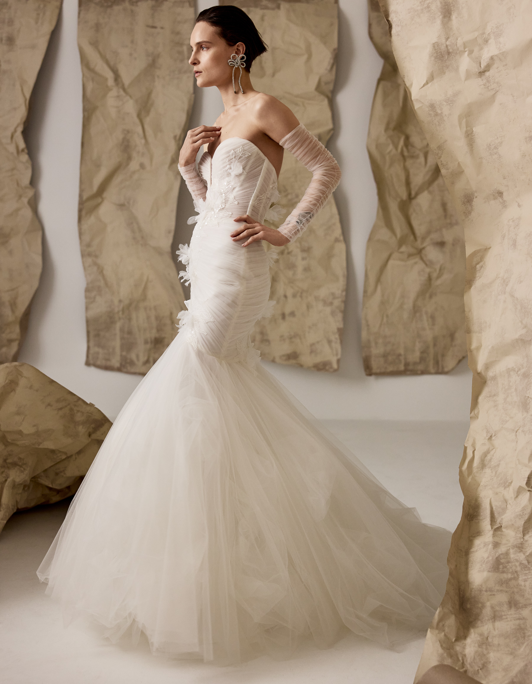 Billie frothy fit-and-flare gown with draped tulle corset, floral lace appliqués, and ruched tulle sleeves, shown close up.