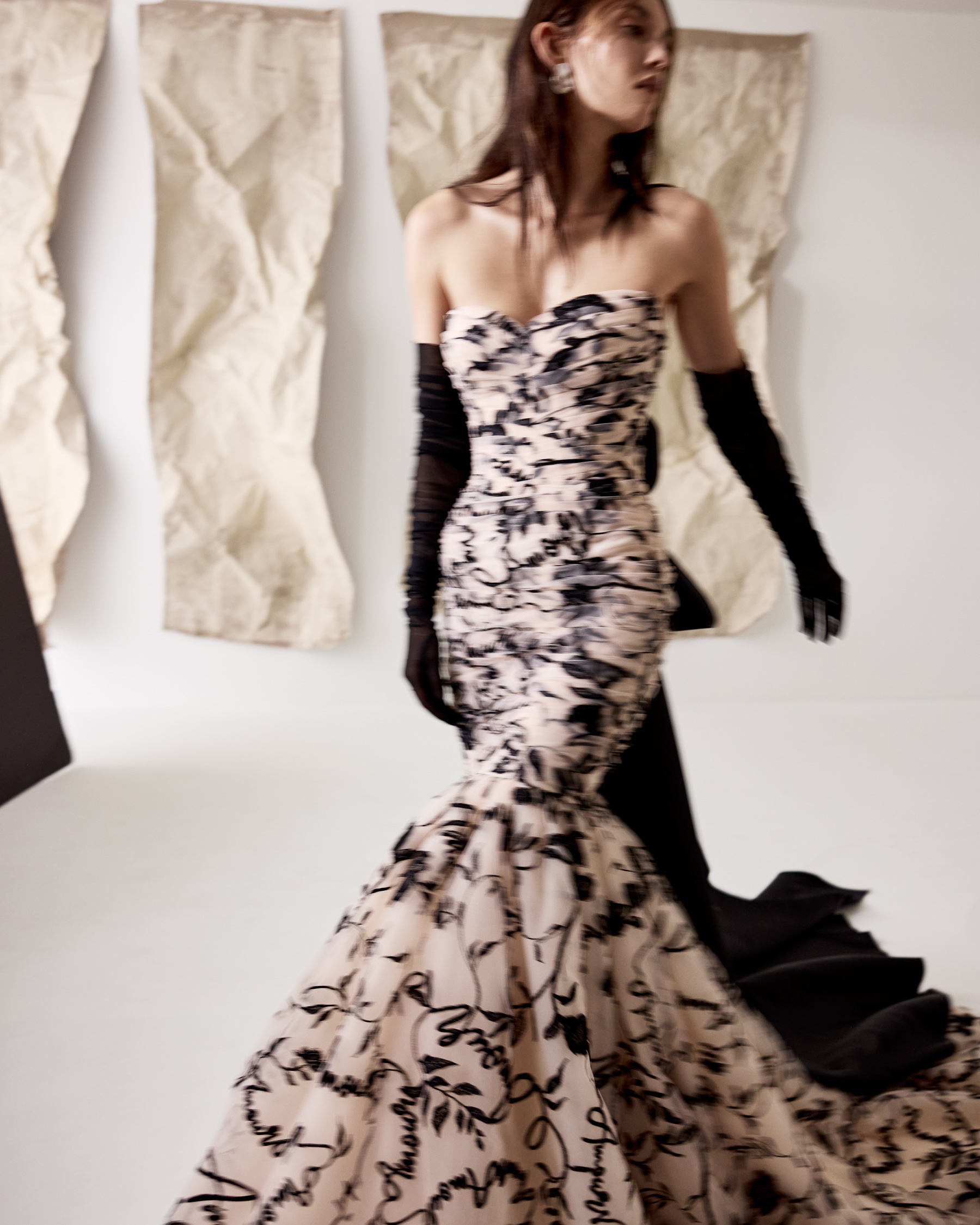 Drew fit-and-flare corset gown in custom Amour embroidered tulle with couture bow and tail detail, shown close up.