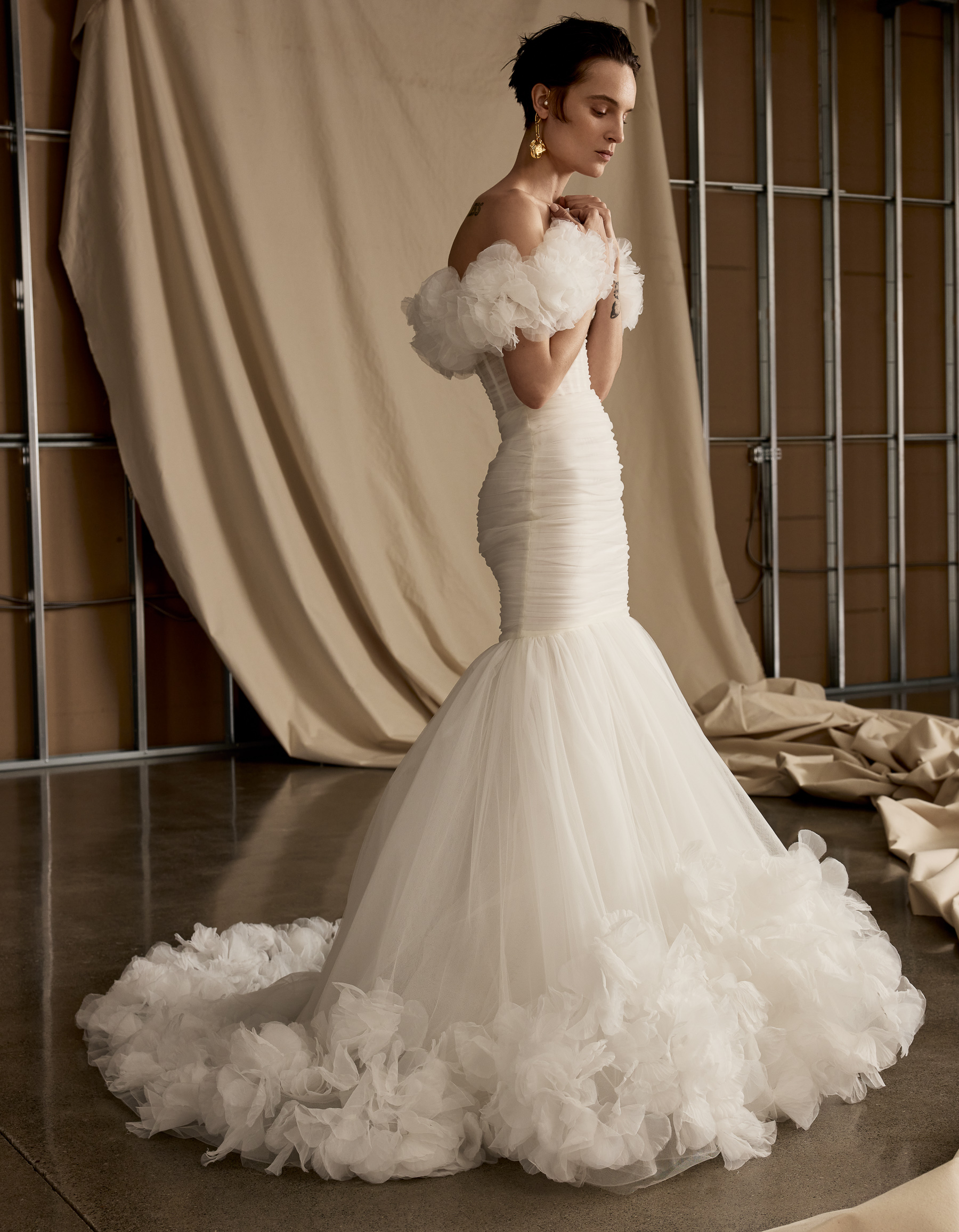 Emery ethereal fit-and-flare gown with hand-draped tulle corset, 3D organza floral hem, and detachable shawl, shown from the front.
