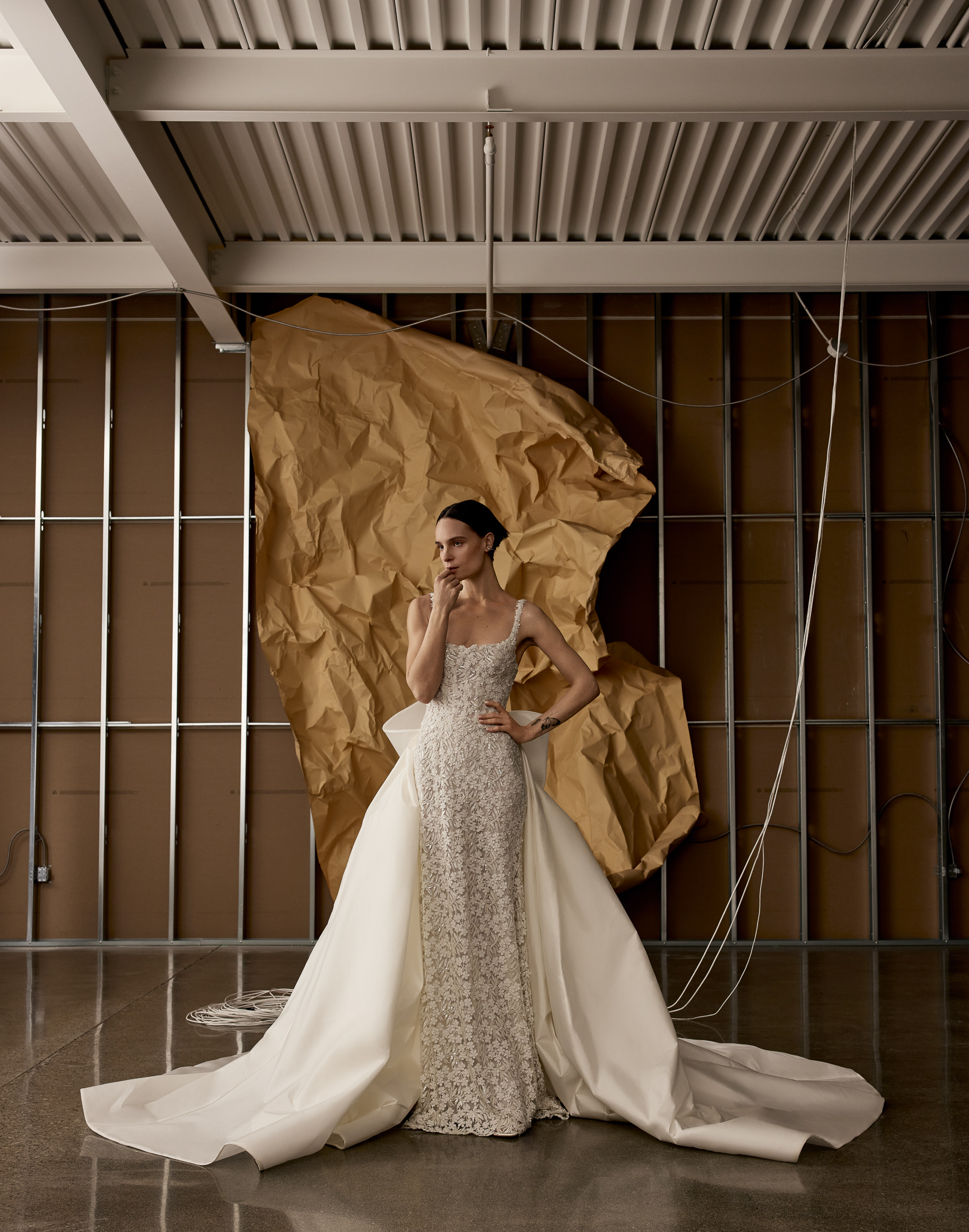 Kyoto corset sheath gown with ballerina neckline, pearl buttons, voluminous bow, and overskirt, shown from the front.