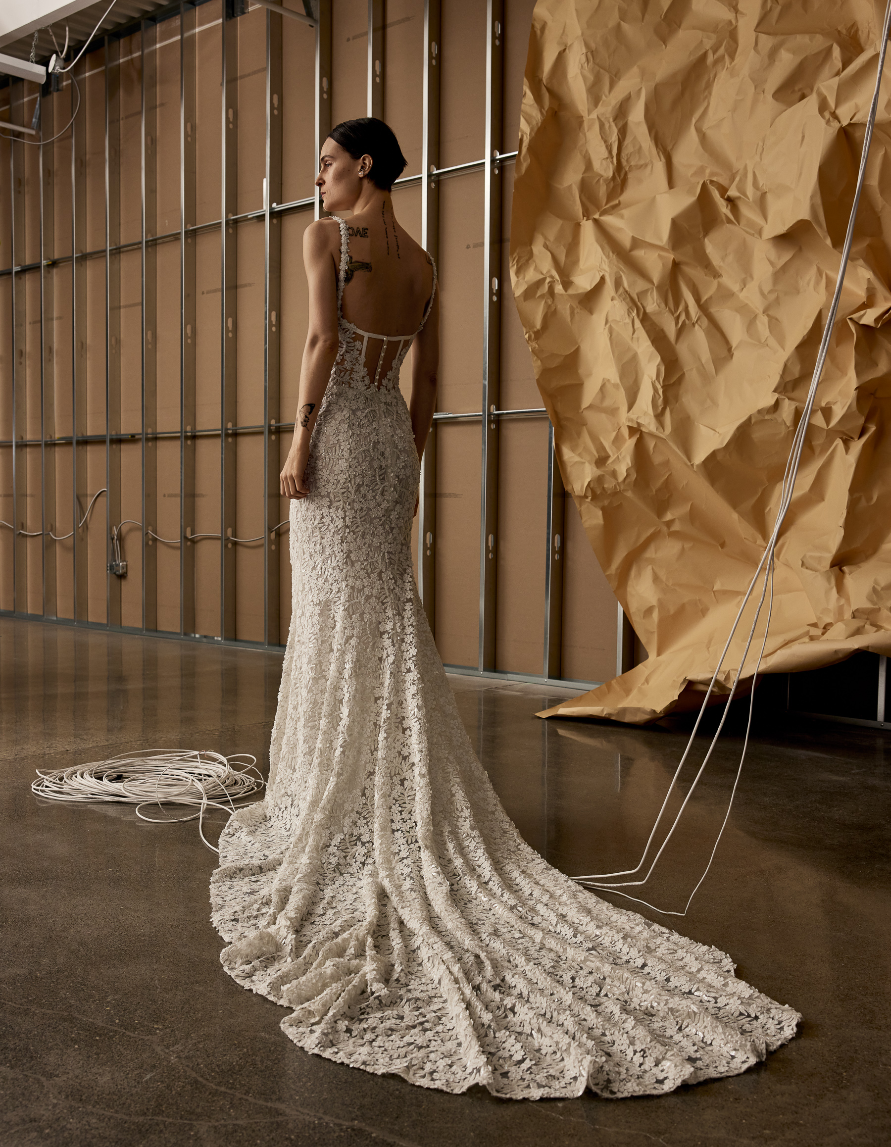 Back view of Kyoto corset sheath gown with pearl buttons, voluminous bow detail, and overskirt.  Image 3 alt text: