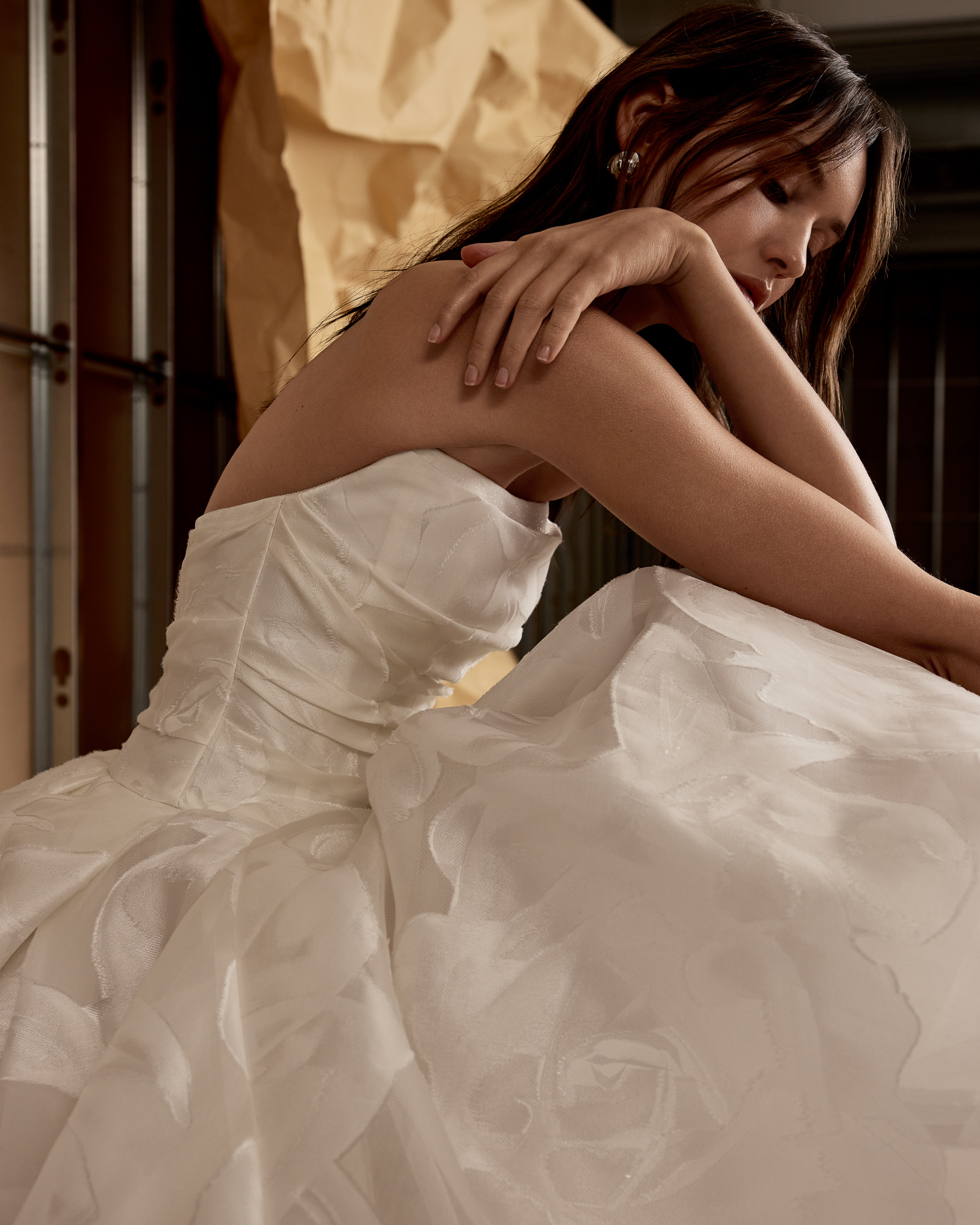 Winslet fil-coupé organza ball gown with organically draped bodice and voluminous pleated skirt, shown close up.