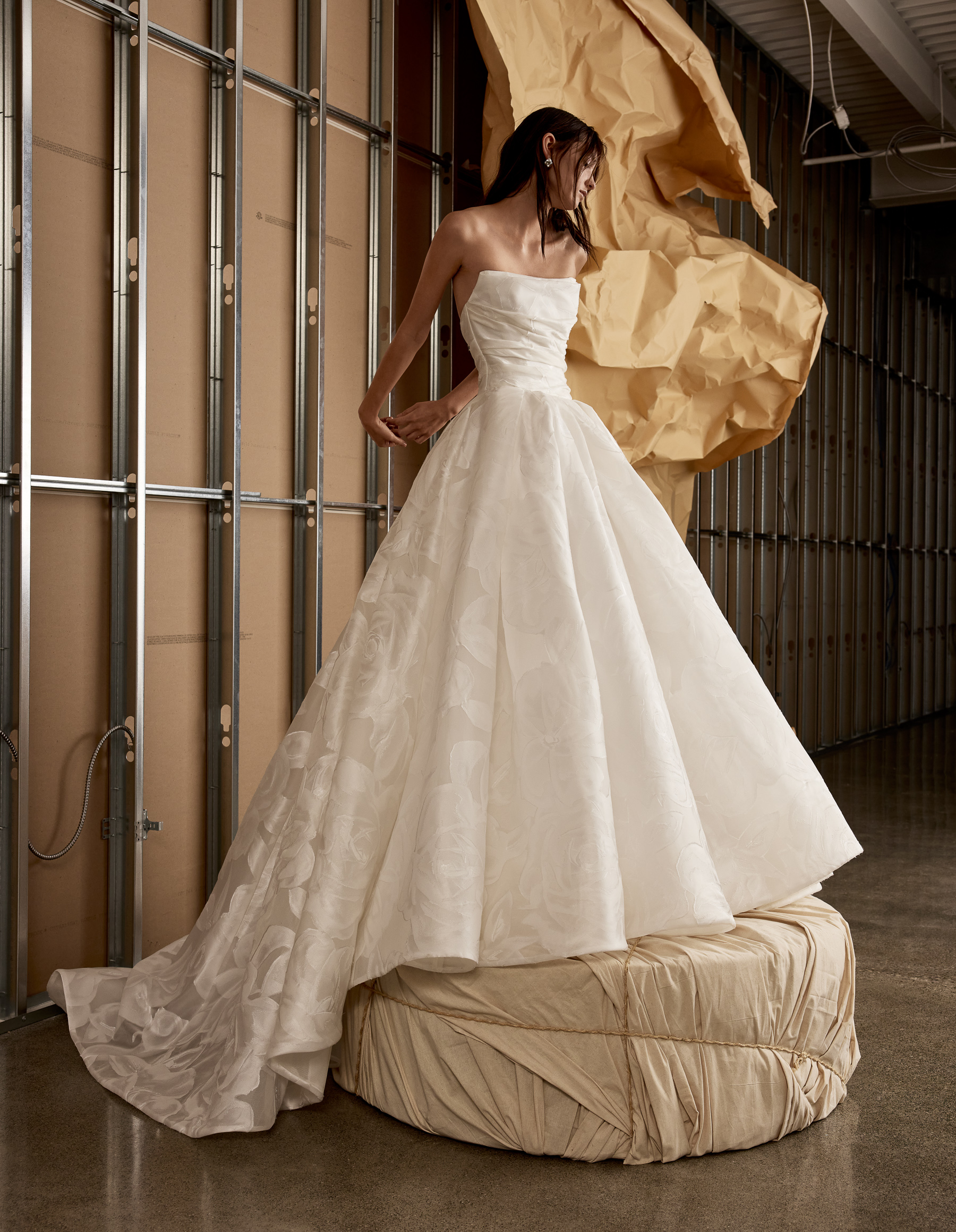 Side view of Winslet fil-coupé organza ball gown with draped bodice and full pleated skirt.