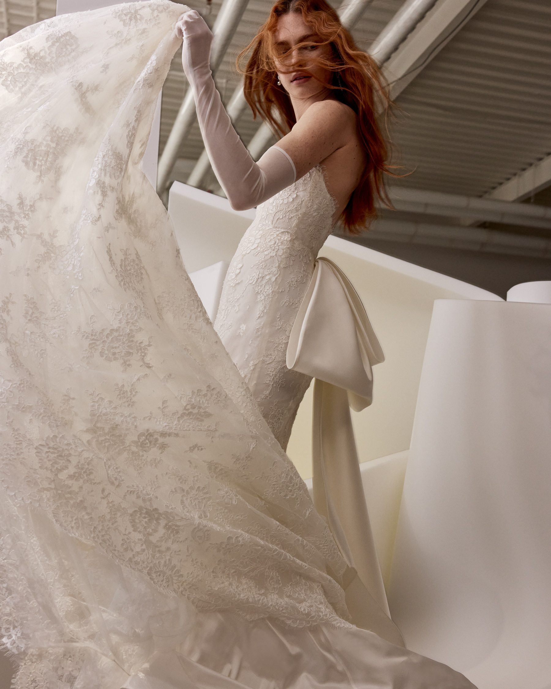 Front view of Chiara fit-and-flare gown with cat-eye sweetheart neckline, satin bow, and flowing skirt.