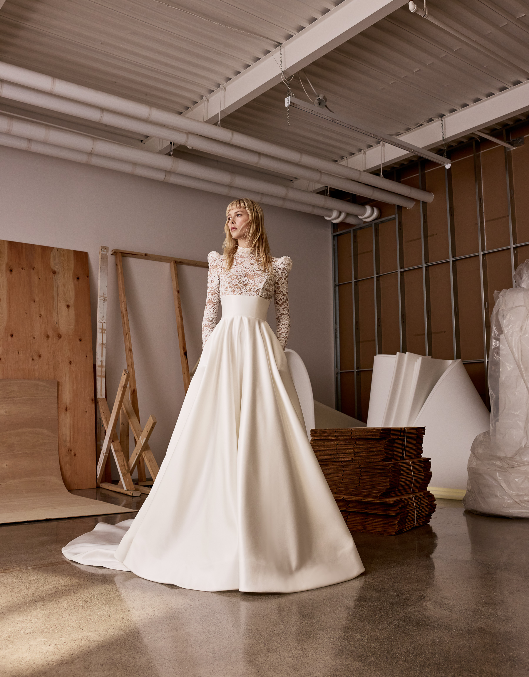 Front view of Codi corded lace ball gown with long sleeves, satin empire midriff, and full skirt.