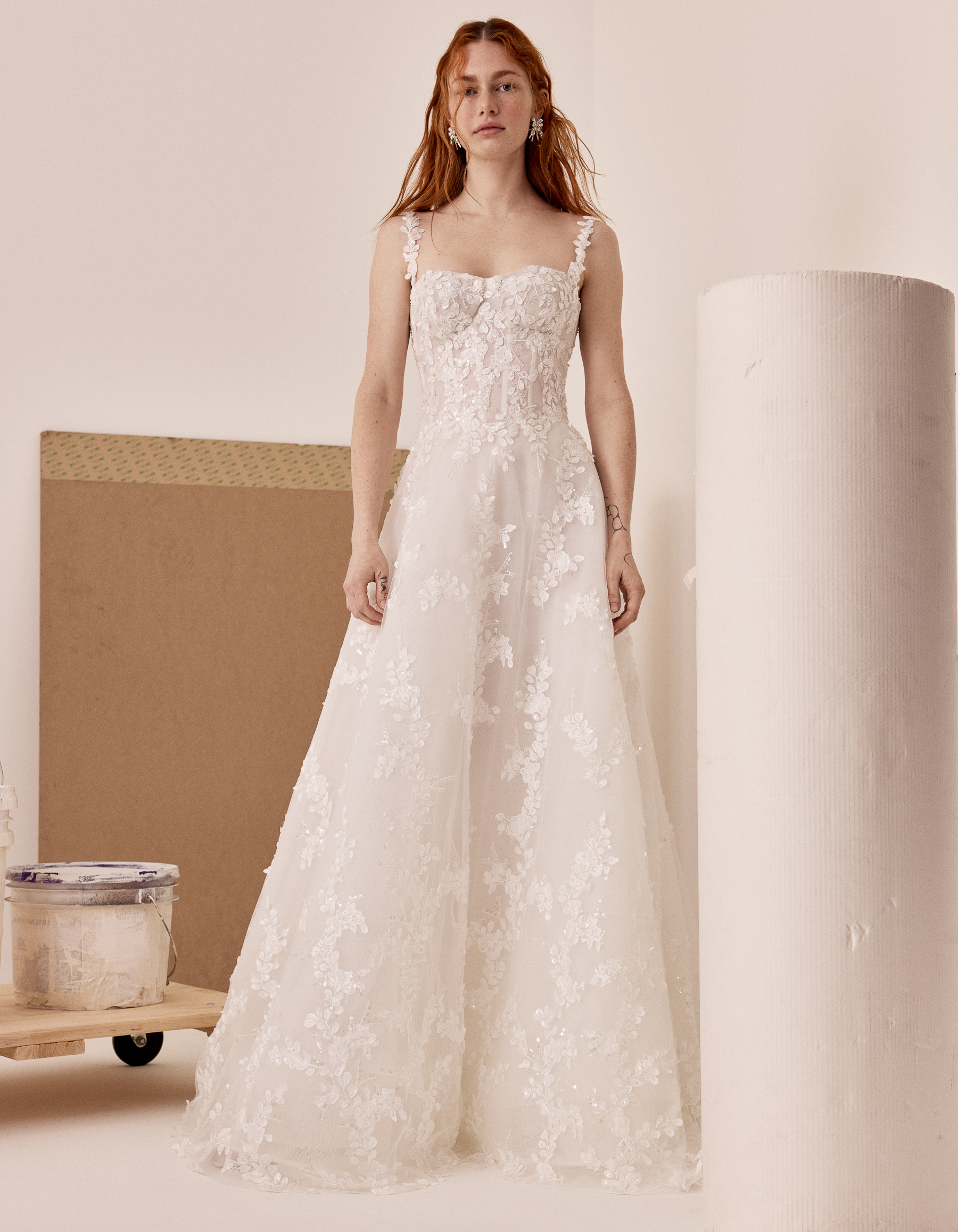 Front view of Lilac floral lace A-line gown with corset bodice, appliquéd straps, and full skirt.