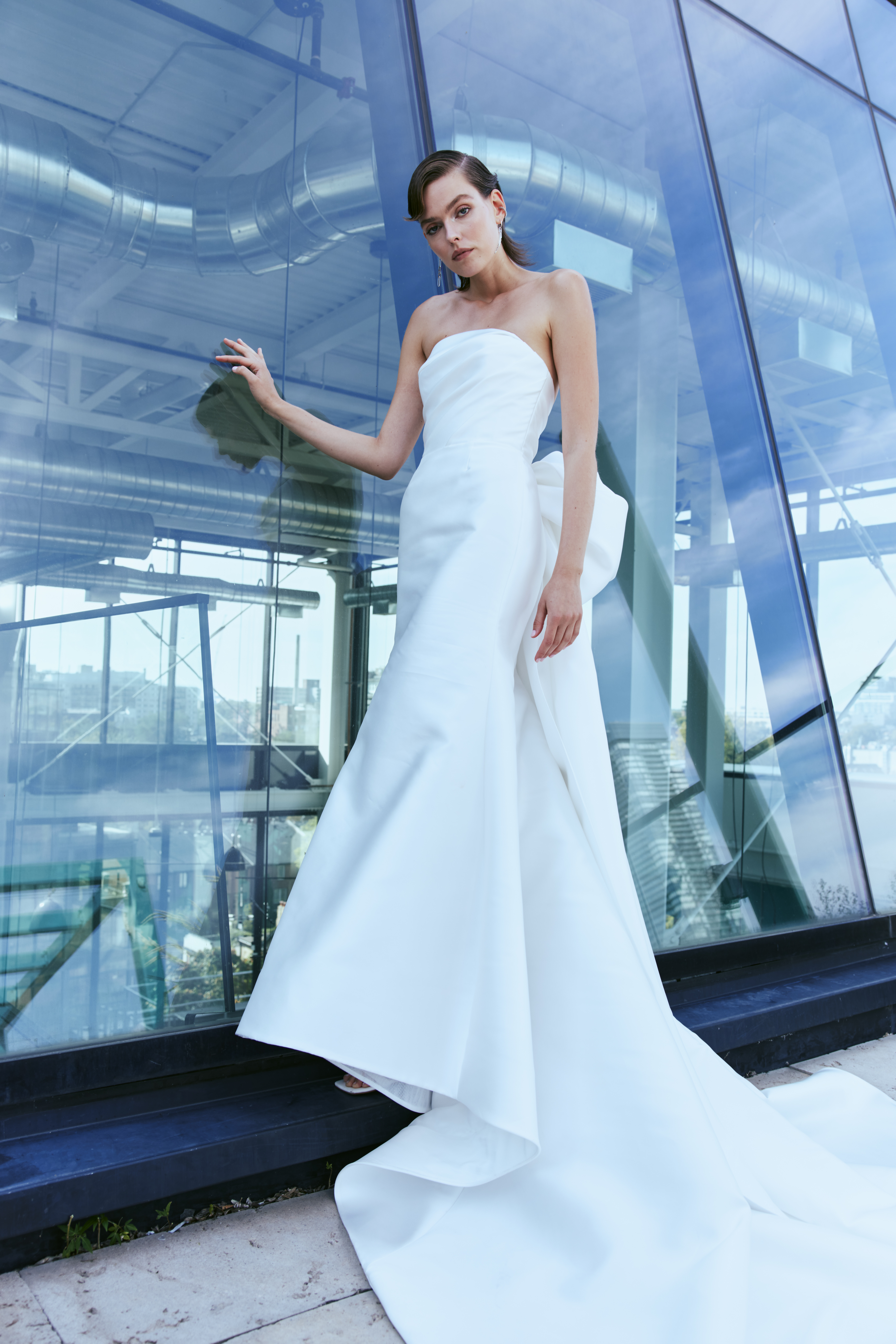 Remi strapless fit-and-flare sheath gown with couture back bow detail and tail, shown from the front.