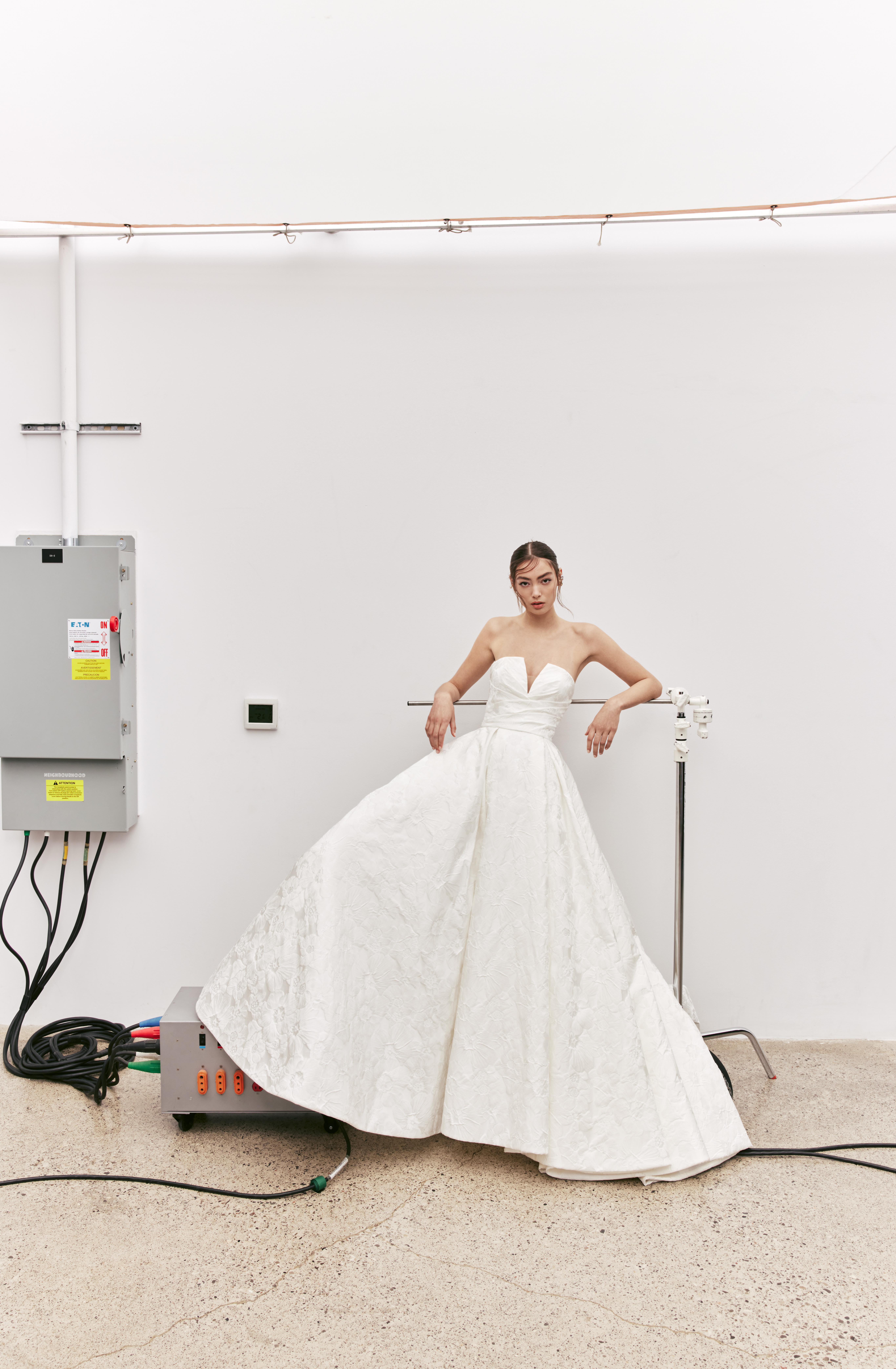 River strapless textured jacquard ball gown with V-notched neckline and draped bodice, shown from the front.
