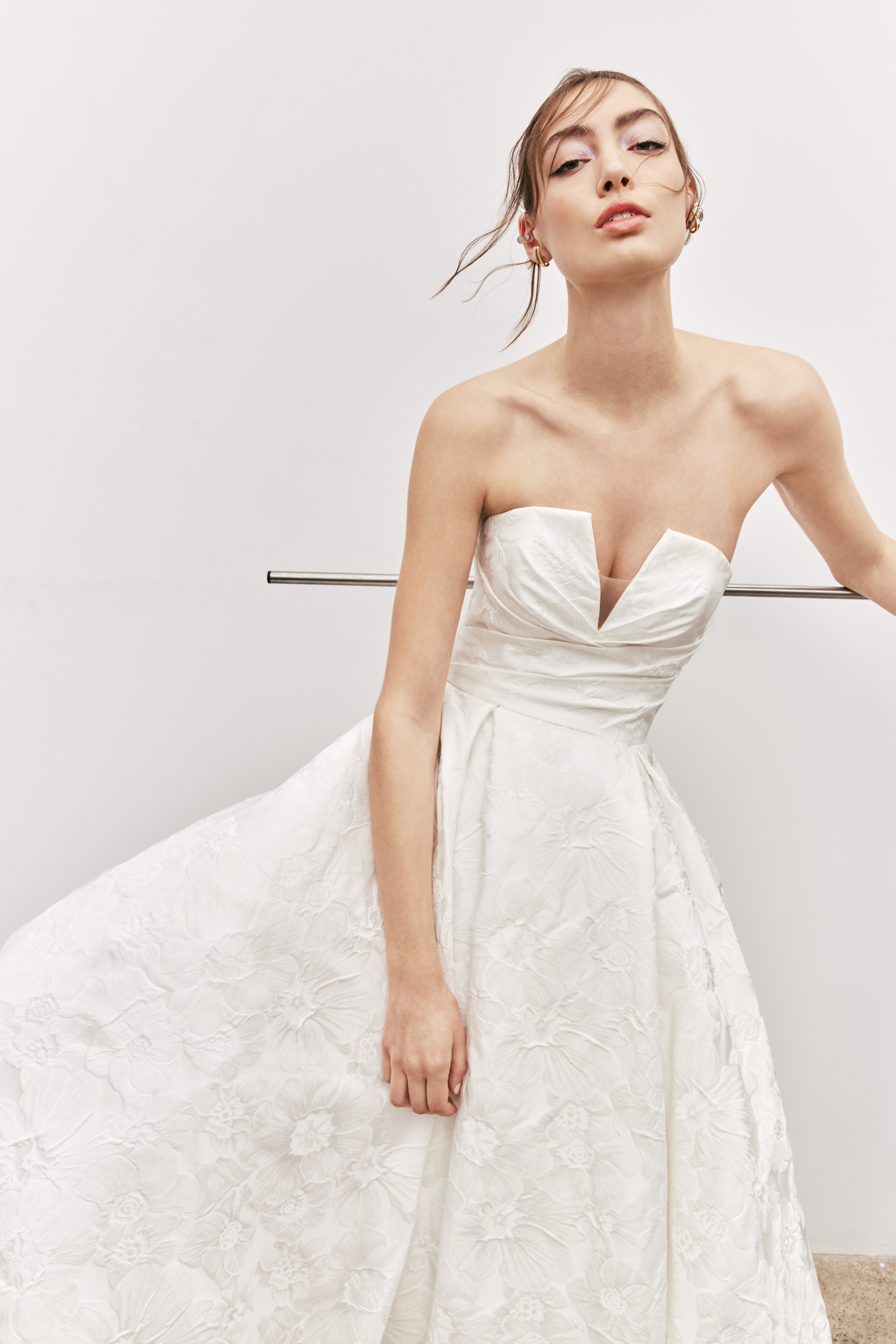 Close-up view of River textured jacquard ball gown with draped bodice and full skirt.