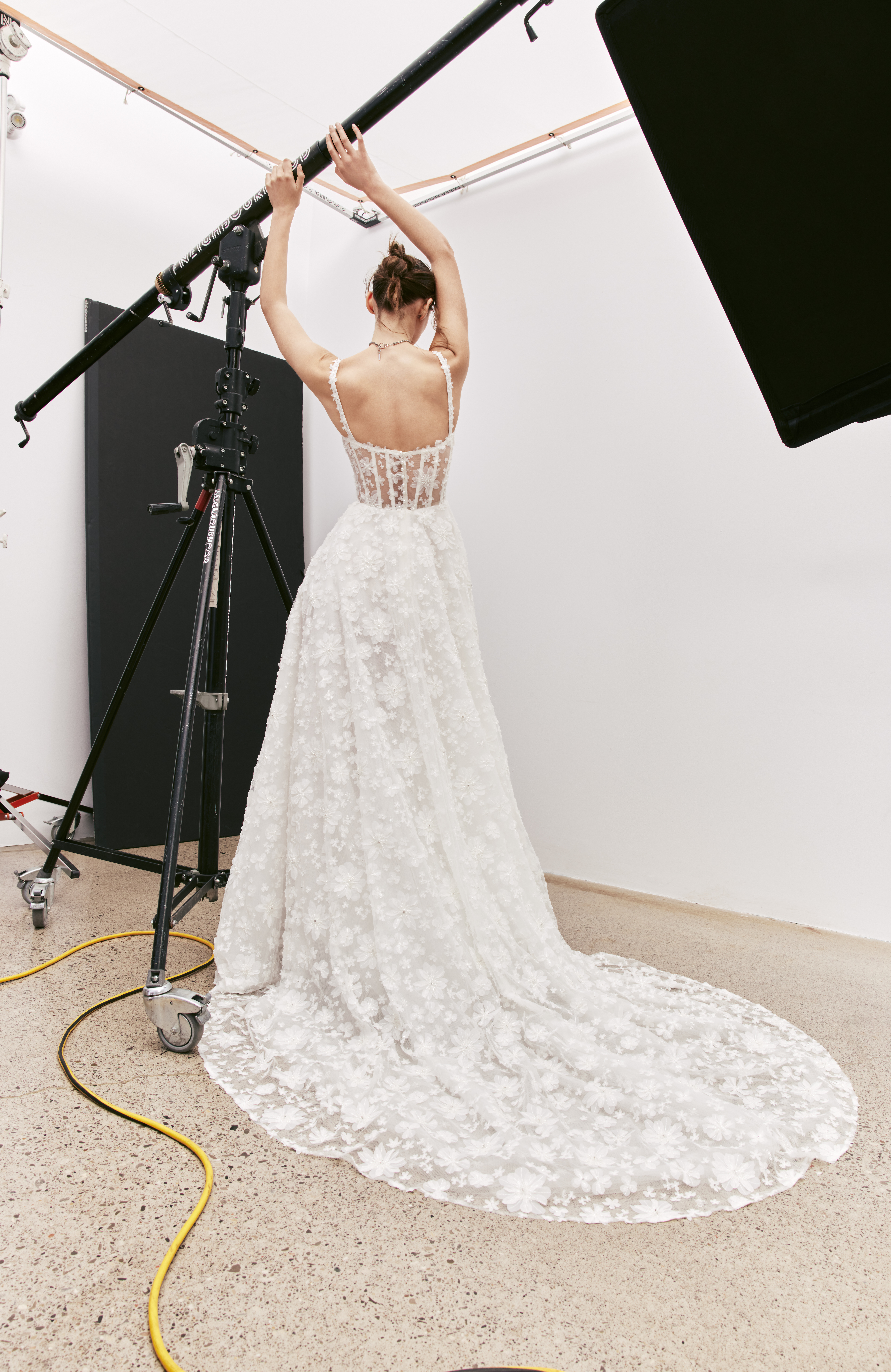 Back view of Bella A-line floral lace gown with boning back detail and full skirt.