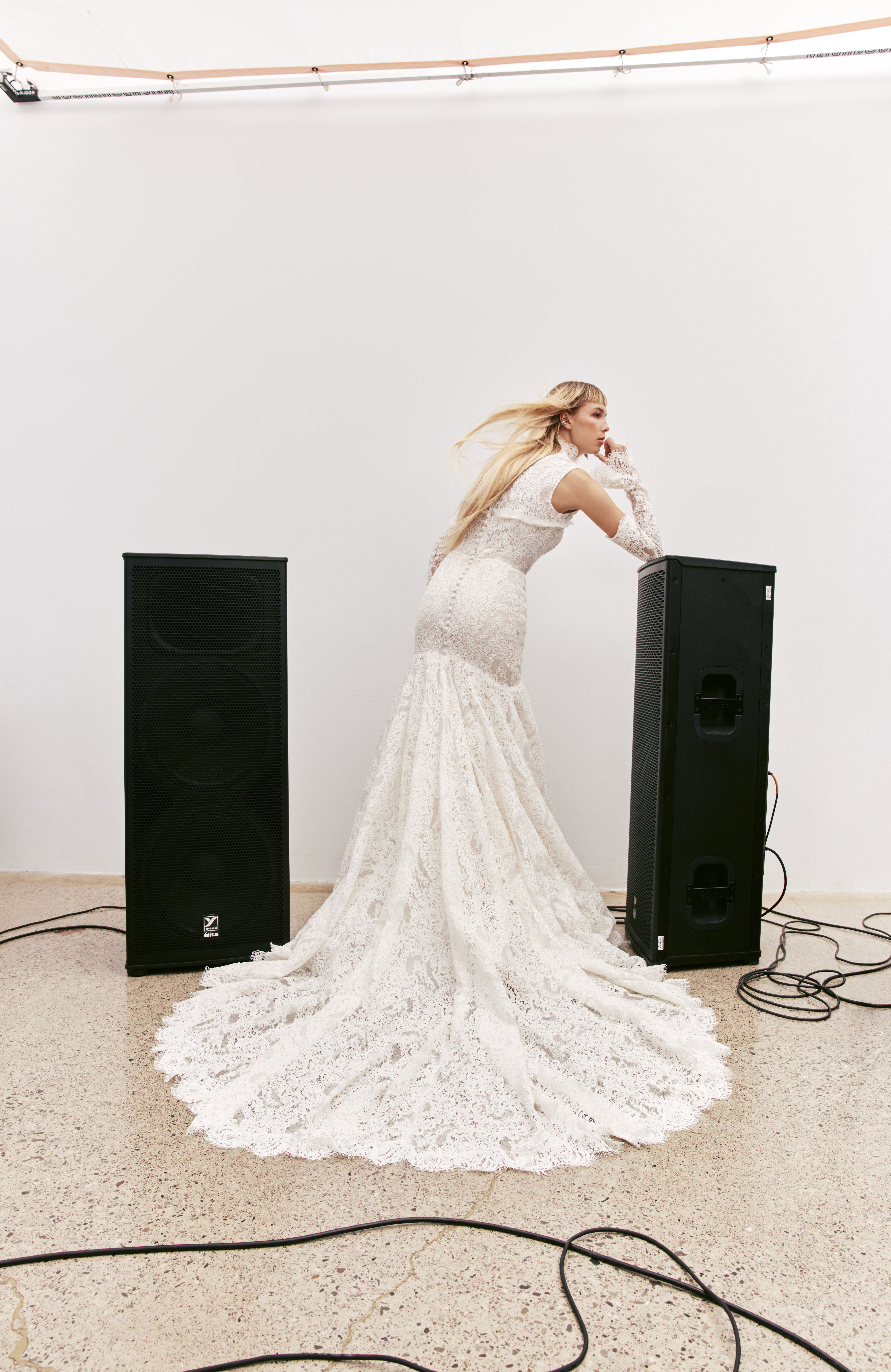 Back view of Kori corded lace fit-and-flare gown with mock neck bolero and detachable sleeves.
