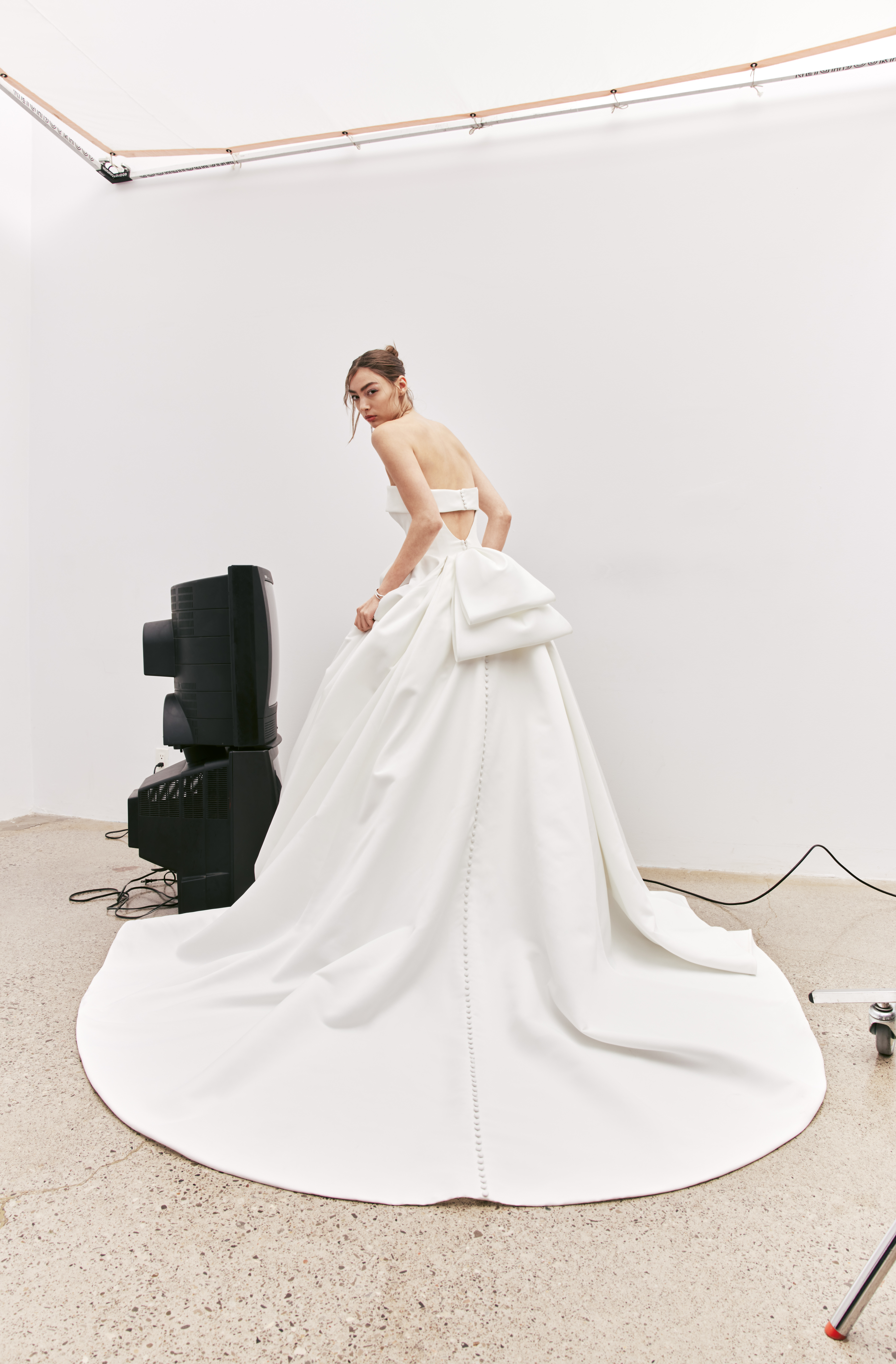 Back view of Maci gown showing the banded strapless bodice and bow detail.
