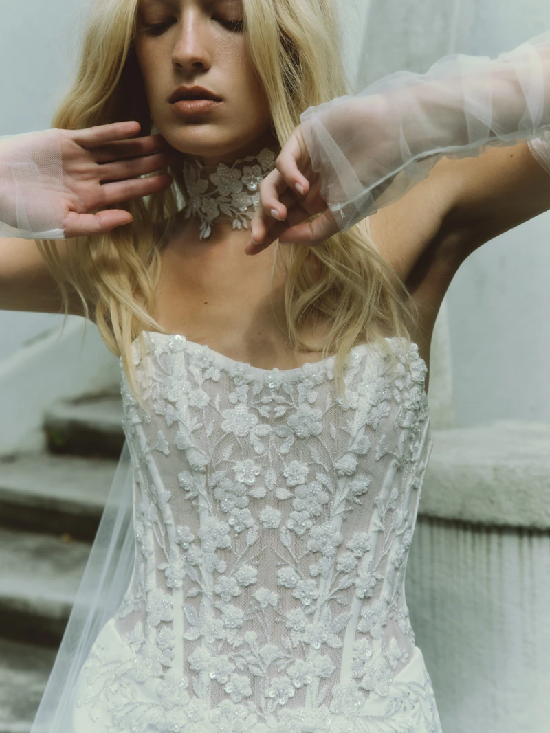 rivini lace dress Fall in Love with LANE Ethereal voluminous ballgown in 3D floral lace, featuring a drop-waist corset, with an effortless hoop petticoat, and buttons accentuating the back to hem. RIVINI SS26 collection