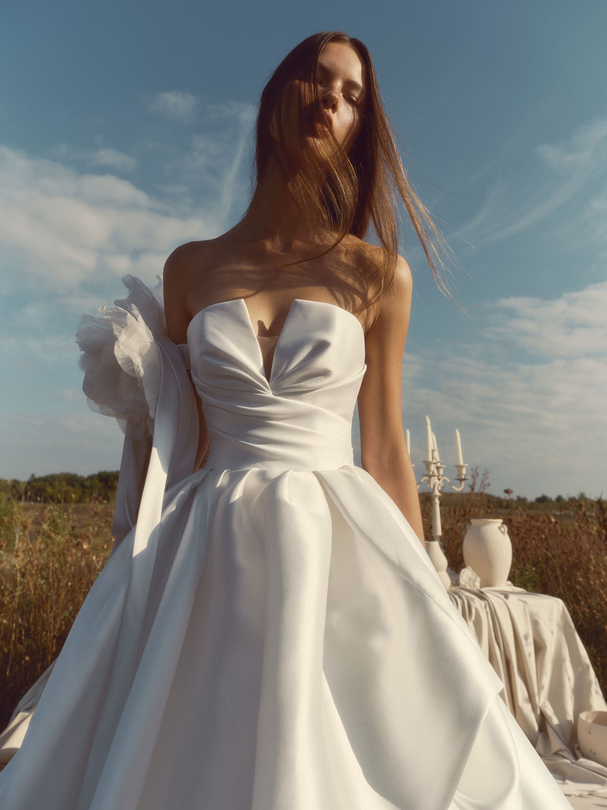 Glow silky strapless ball gown with sculpted sweetheart bodice, subtle V-front, and voluminous pleated skirt.