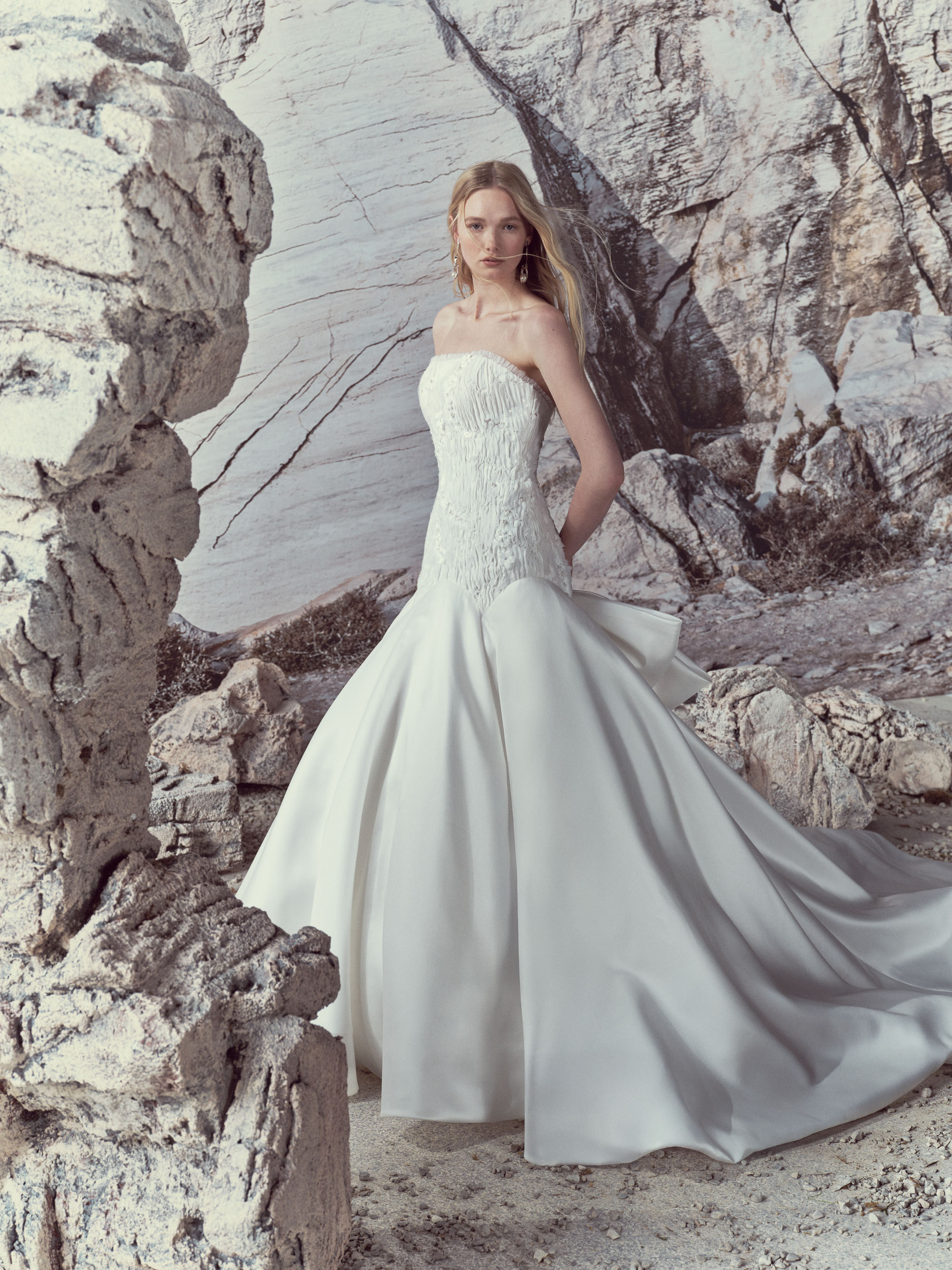 Back view of Elise showing the double-overlapped bow, pearl buttons, and extended cathedral train.