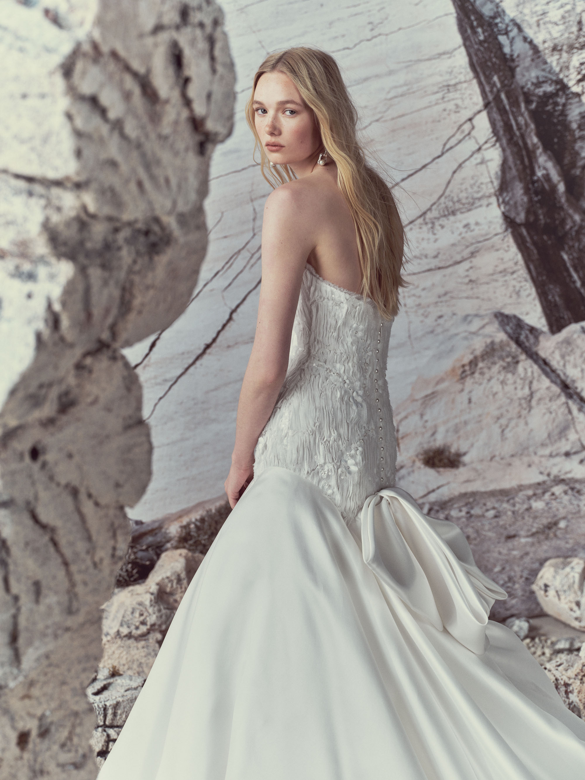 Elise RIVINI SS27 strapless ball gown with an elongated bodice, 3D gazar flowers, pearl detailing, and a light silk gazar skirt.