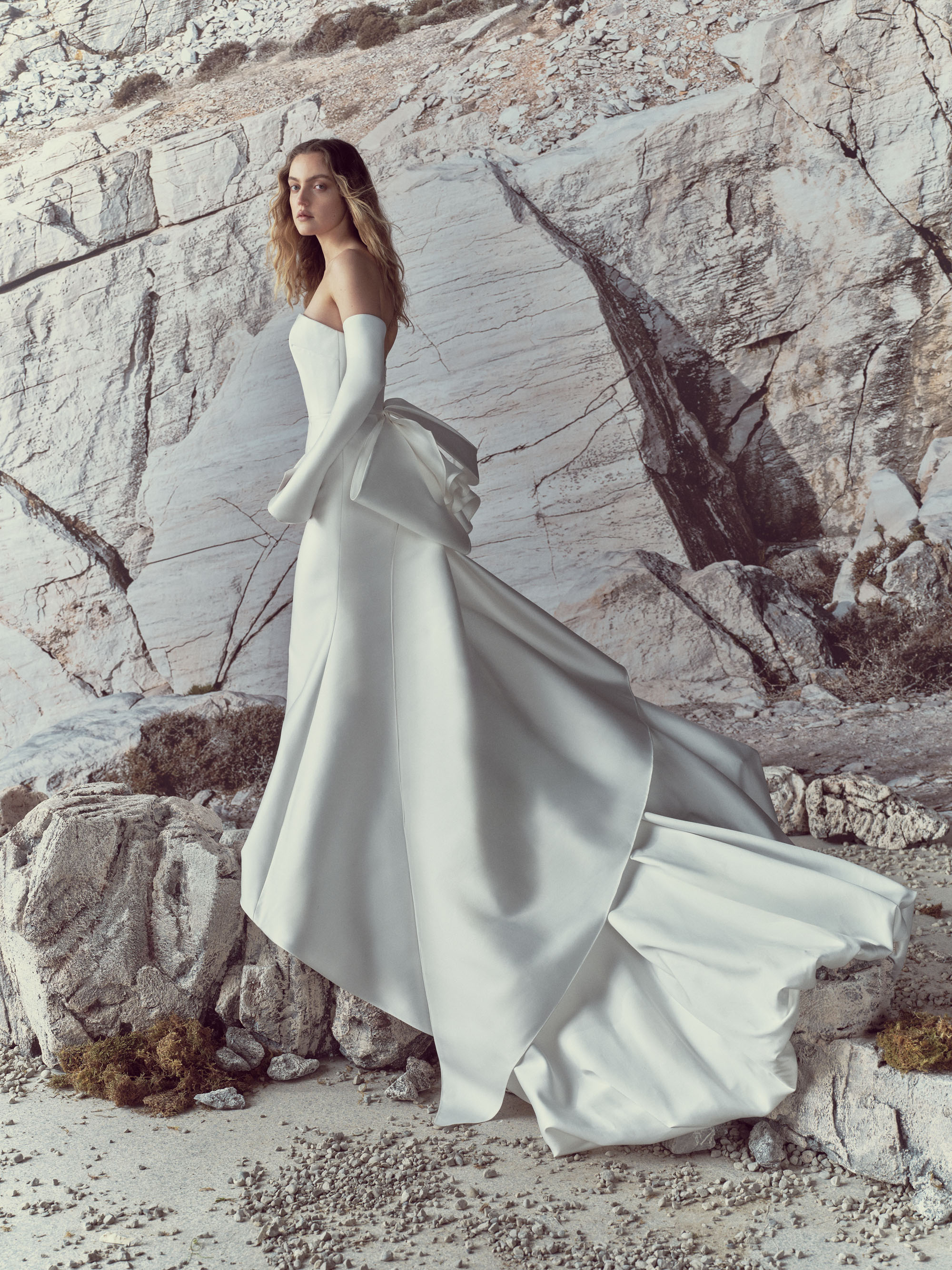 Odette RIVINI SS27 strapless silk magnolia mermaid gown with detachable calla lily sleeves, oversized couture bow, and cascading train.