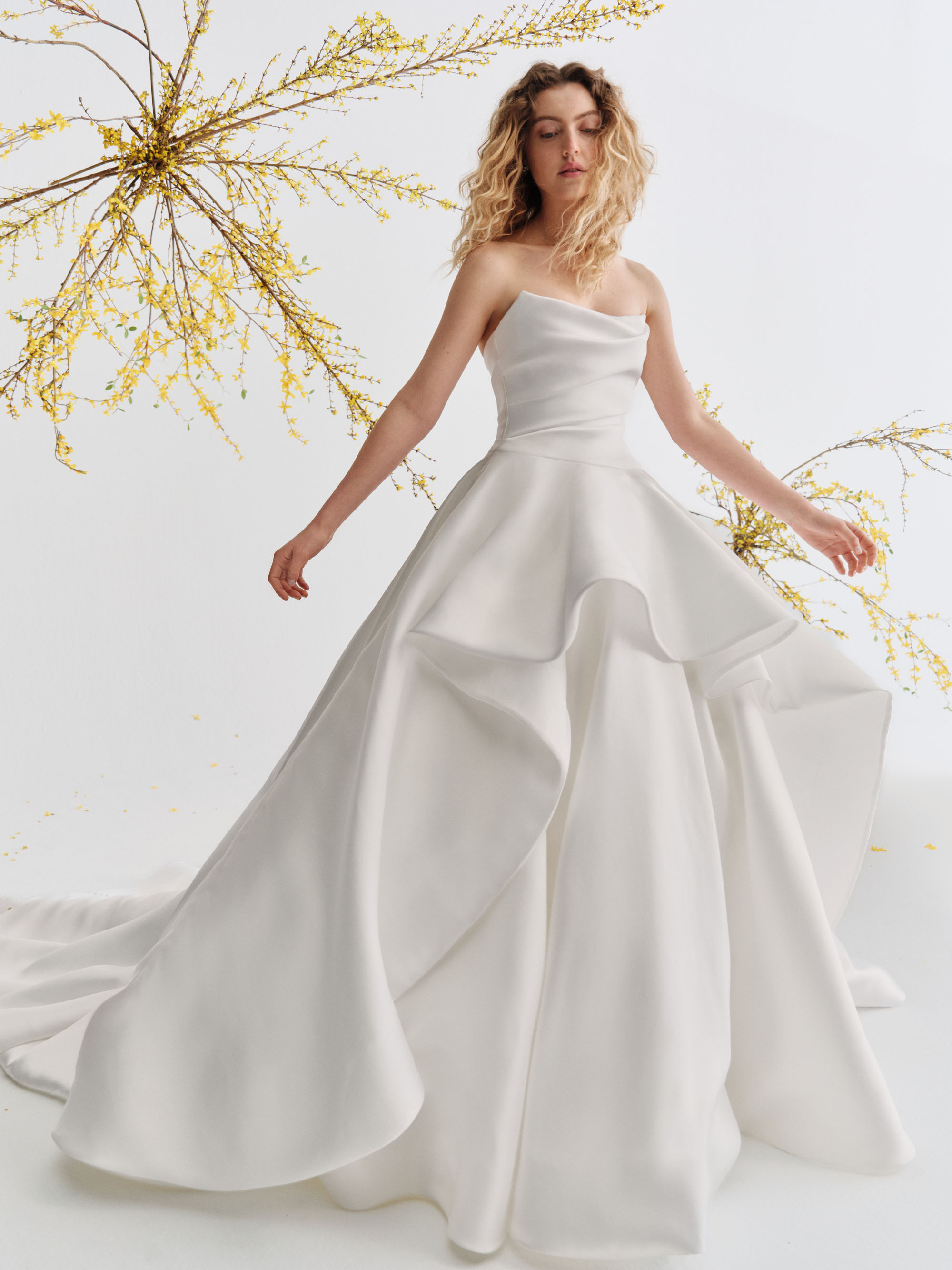 Caelen Alyne SS27 mikado ball gown with a softly draped cat-eye bodice and voluminous tiered skirt, shown from the front.