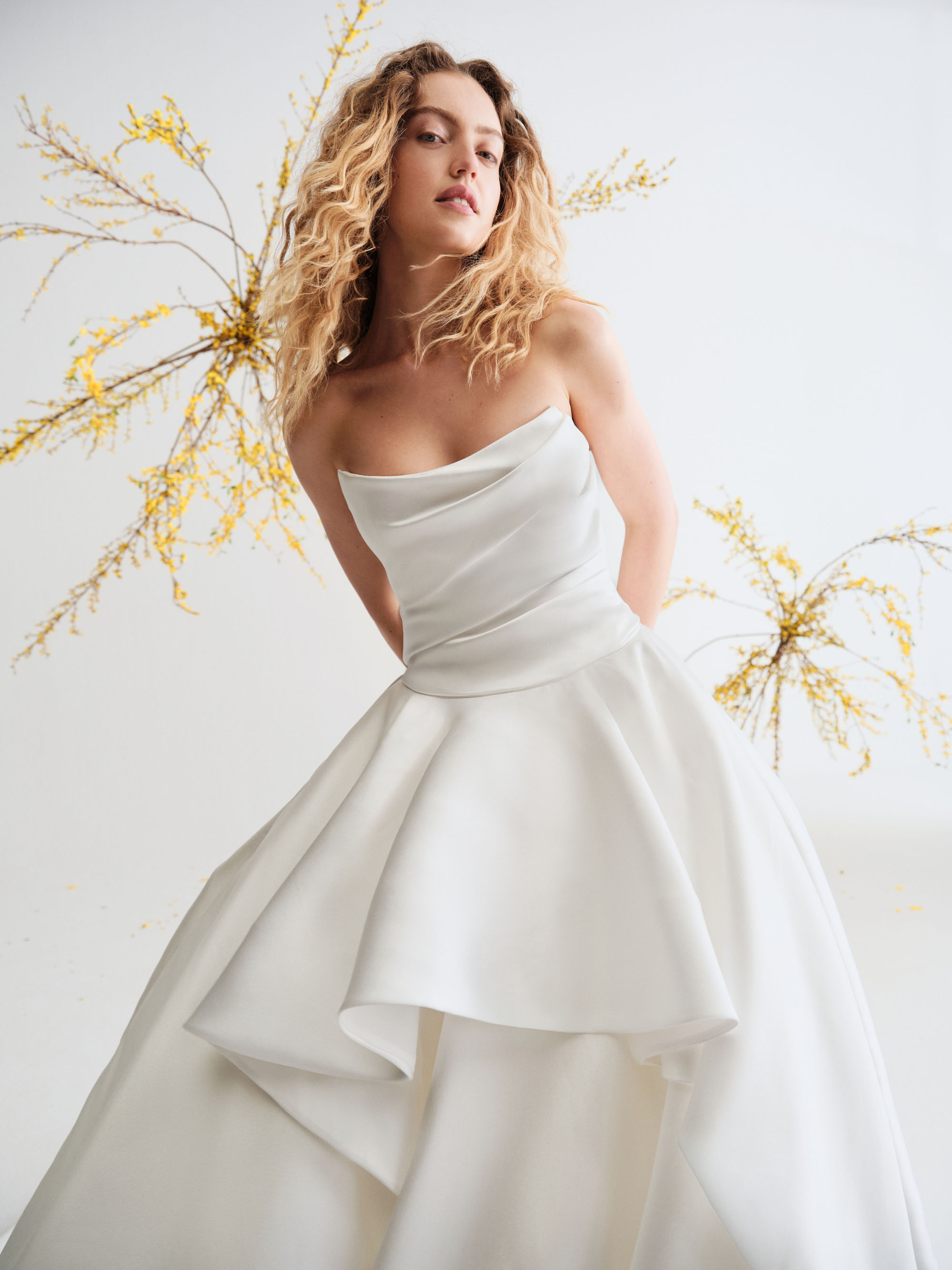 Close-up of Caelen showing the sculpted cat-eye neckline, supple bodice draping, and layered mikado skirt.
