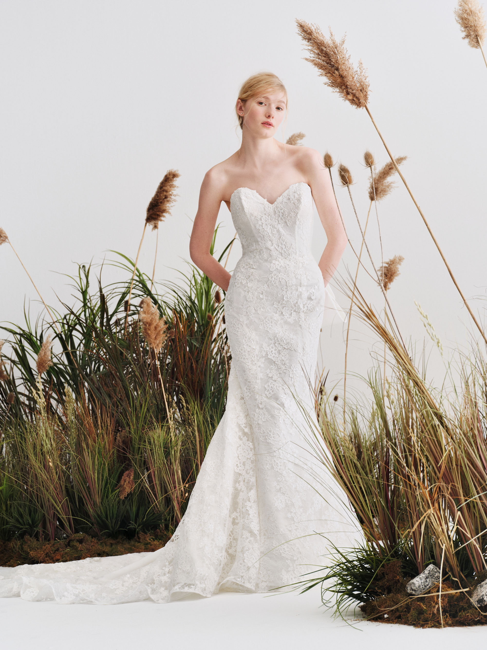 Cara Alyne SS27 strapless sweetheart fit-and-flare gown in Chantilly lace with corded floral embroidery and a soft cascading train.