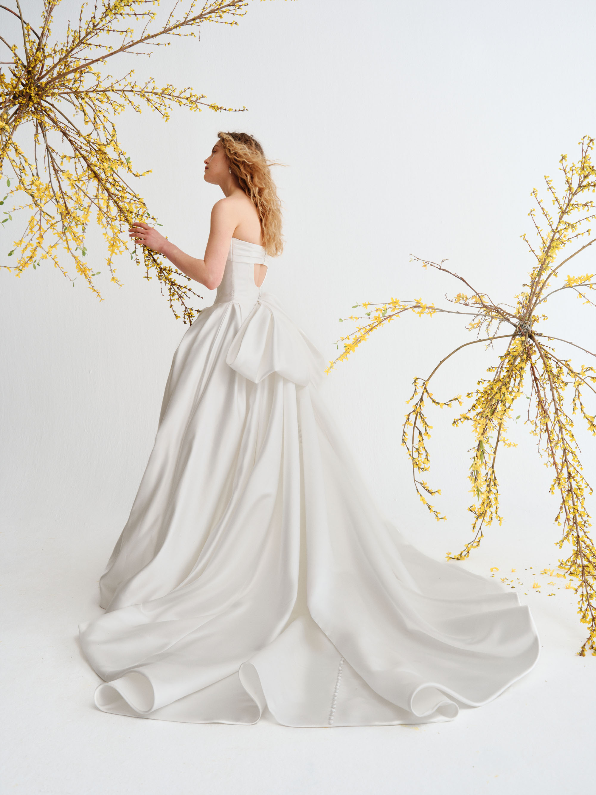 Reeve Alyne SS27 grand satin ball gown with a strapless panelled bodice, softly draped cuff neckline, and voluminous skirt, shown from the front.