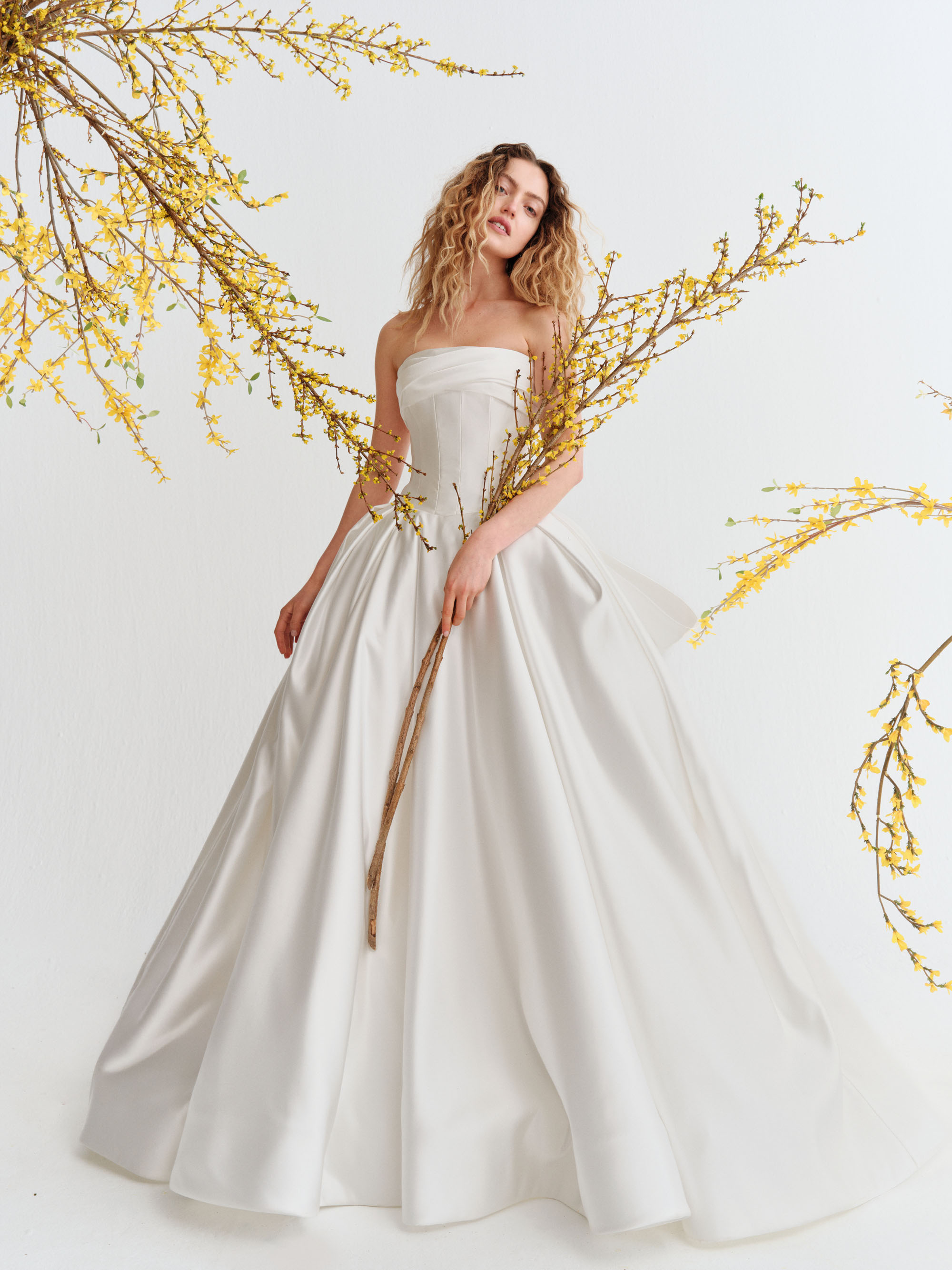 Reeve Alyne SS27 grand satin ballgown with a strapless panelled bodice, draped neckline, and voluminous skirt.