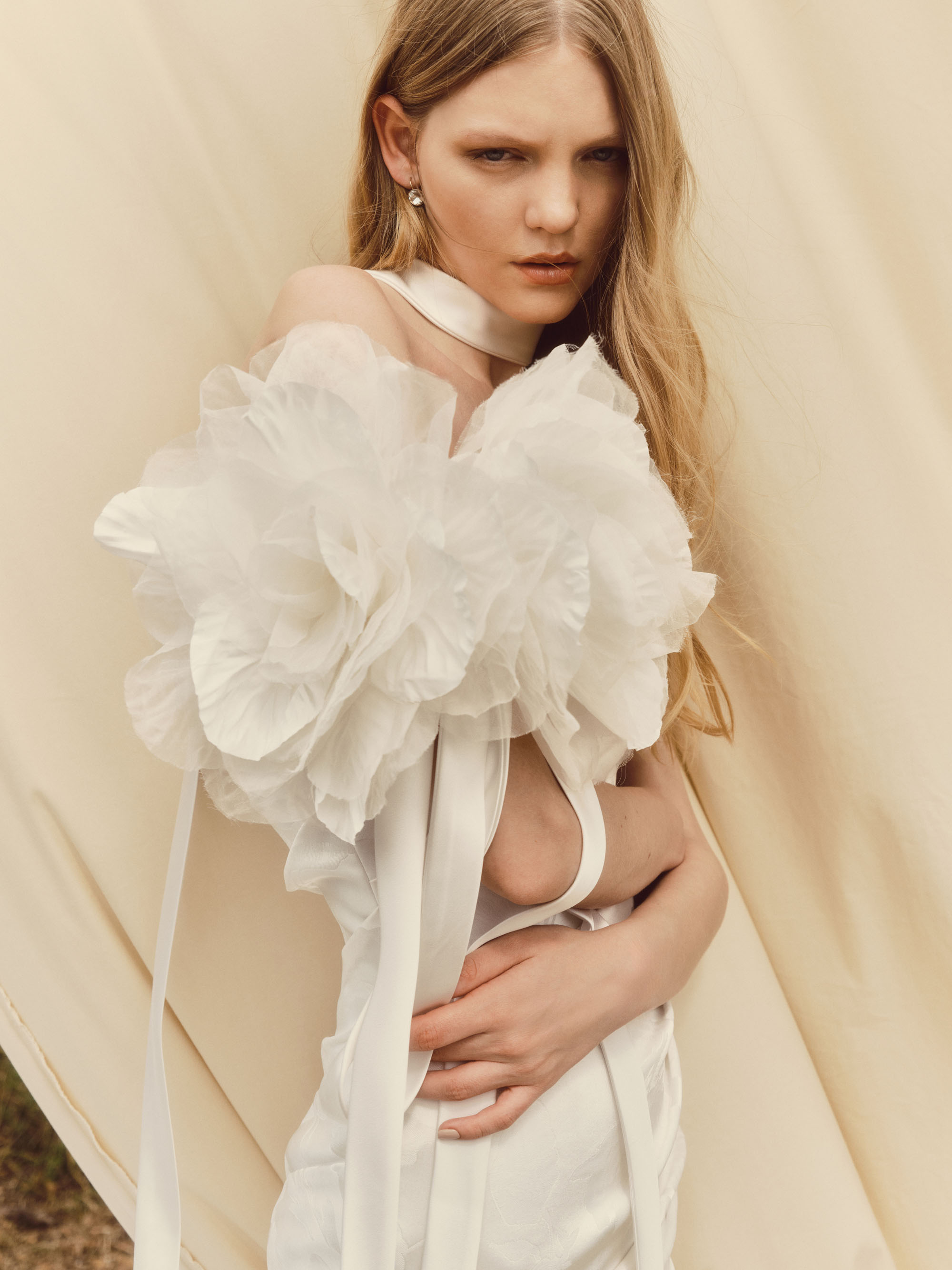 Cloud off-the-shoulder organza sleeve with pressed rose detail and trailing silk streamers, shown draped across the shoulders.