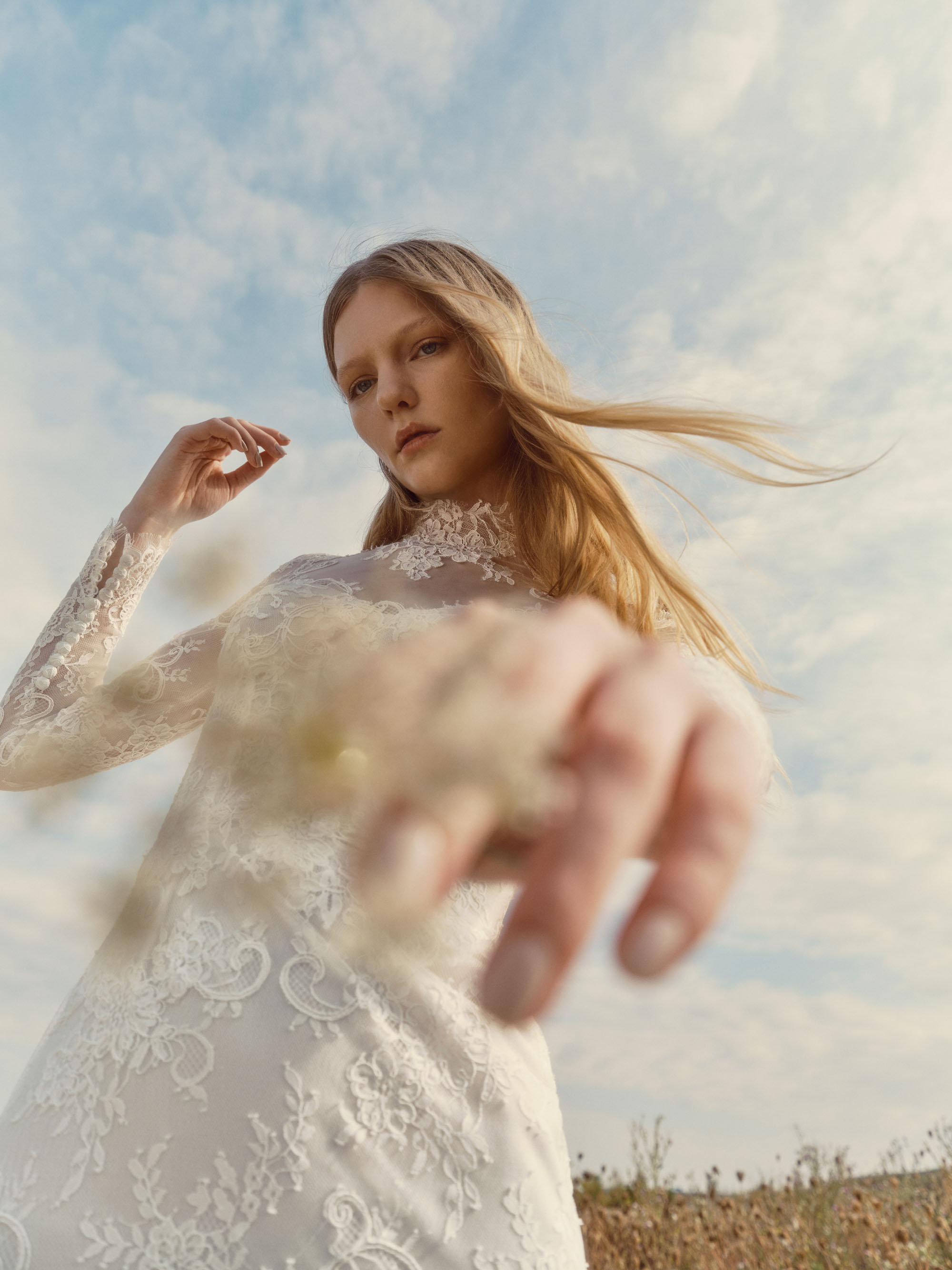 Close-up of Fawn showing the hand-appliquéd lace, sheer sleeves, and soft stand collar.