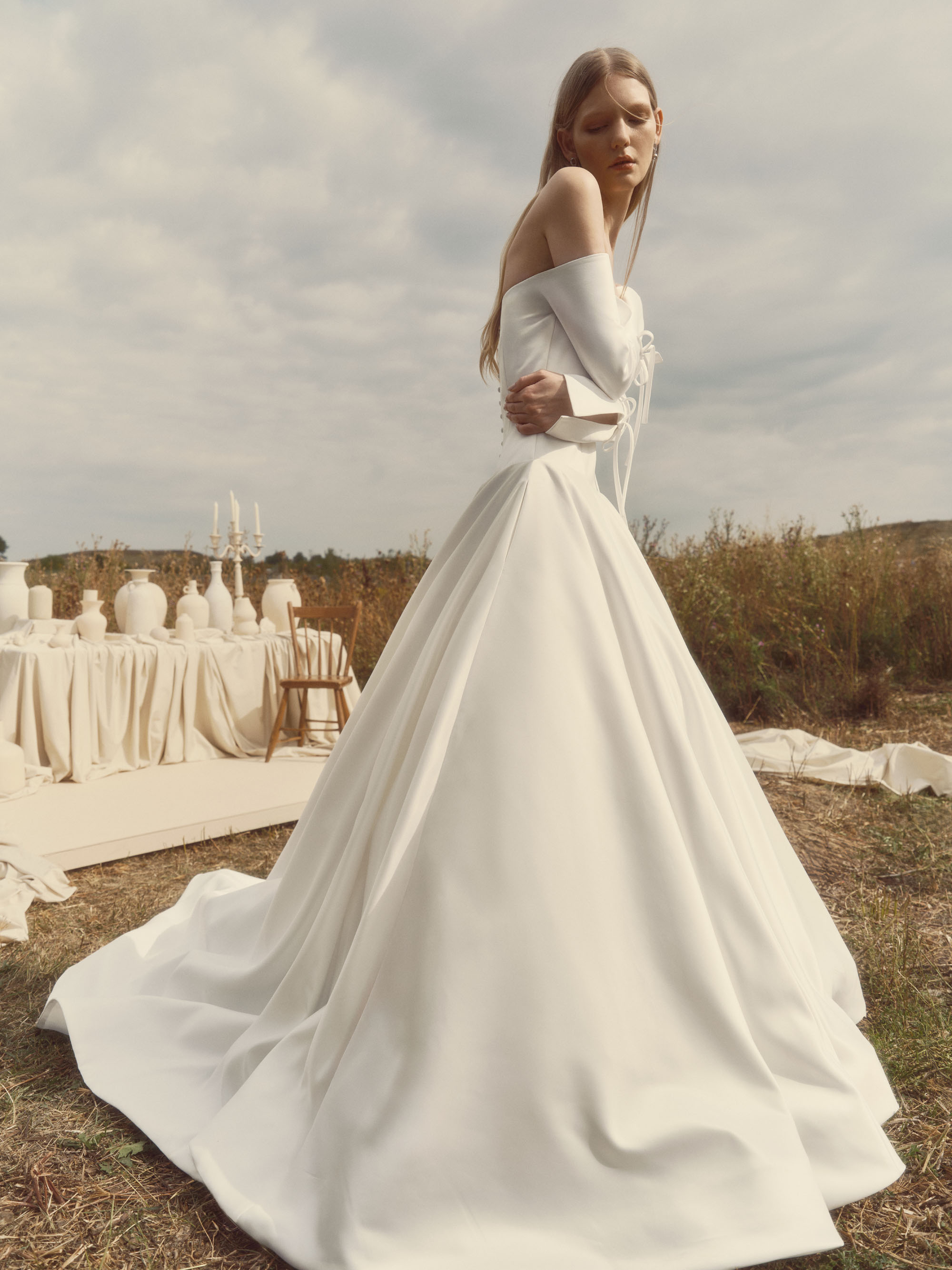 Side view of Grace showing the off-the-shoulder neckline, full skirt, and flowing train.