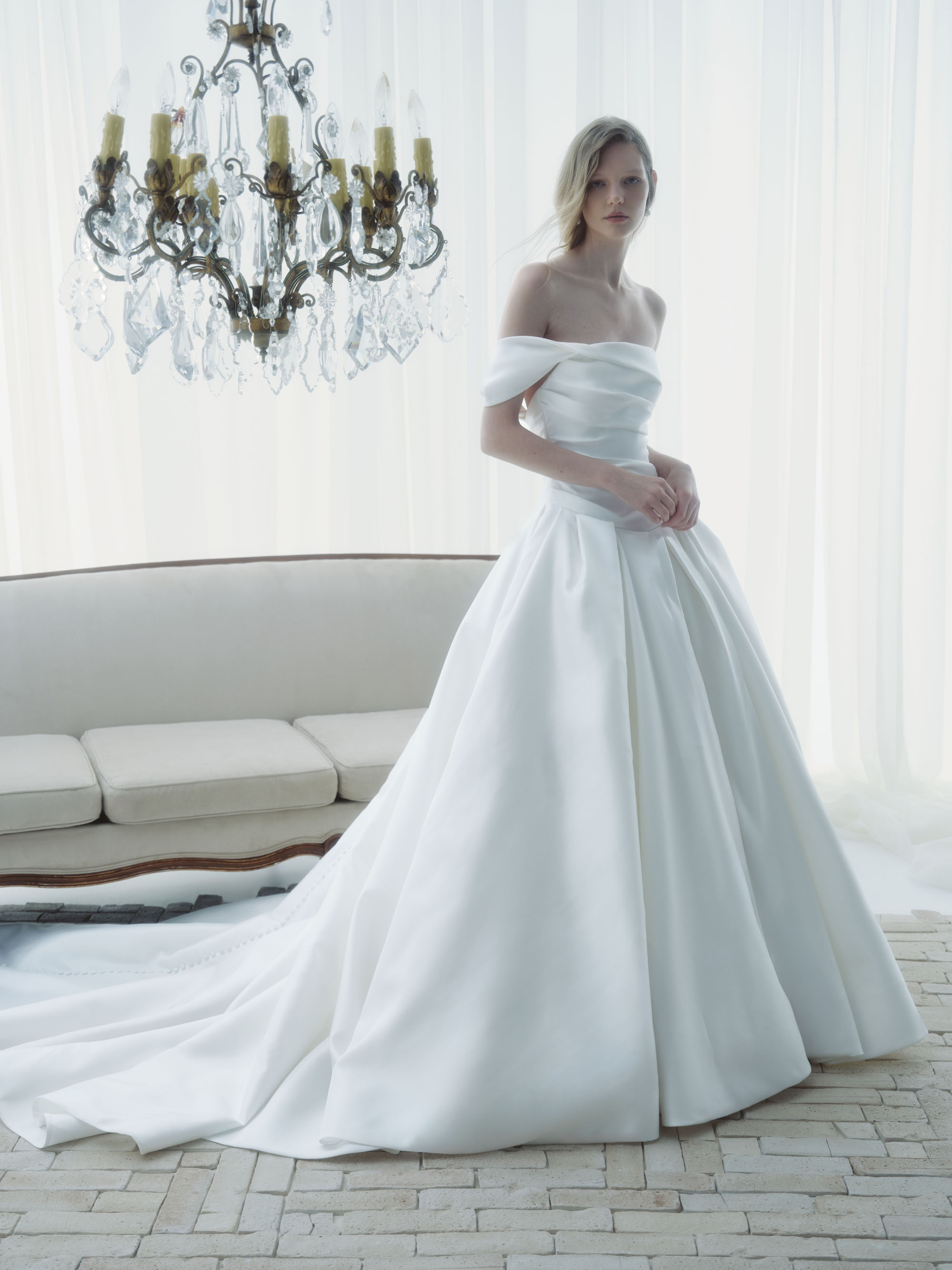 Front view of Aura ball gown showing the sculptural portrait collar, softly draped bodice, and voluminous skirt.