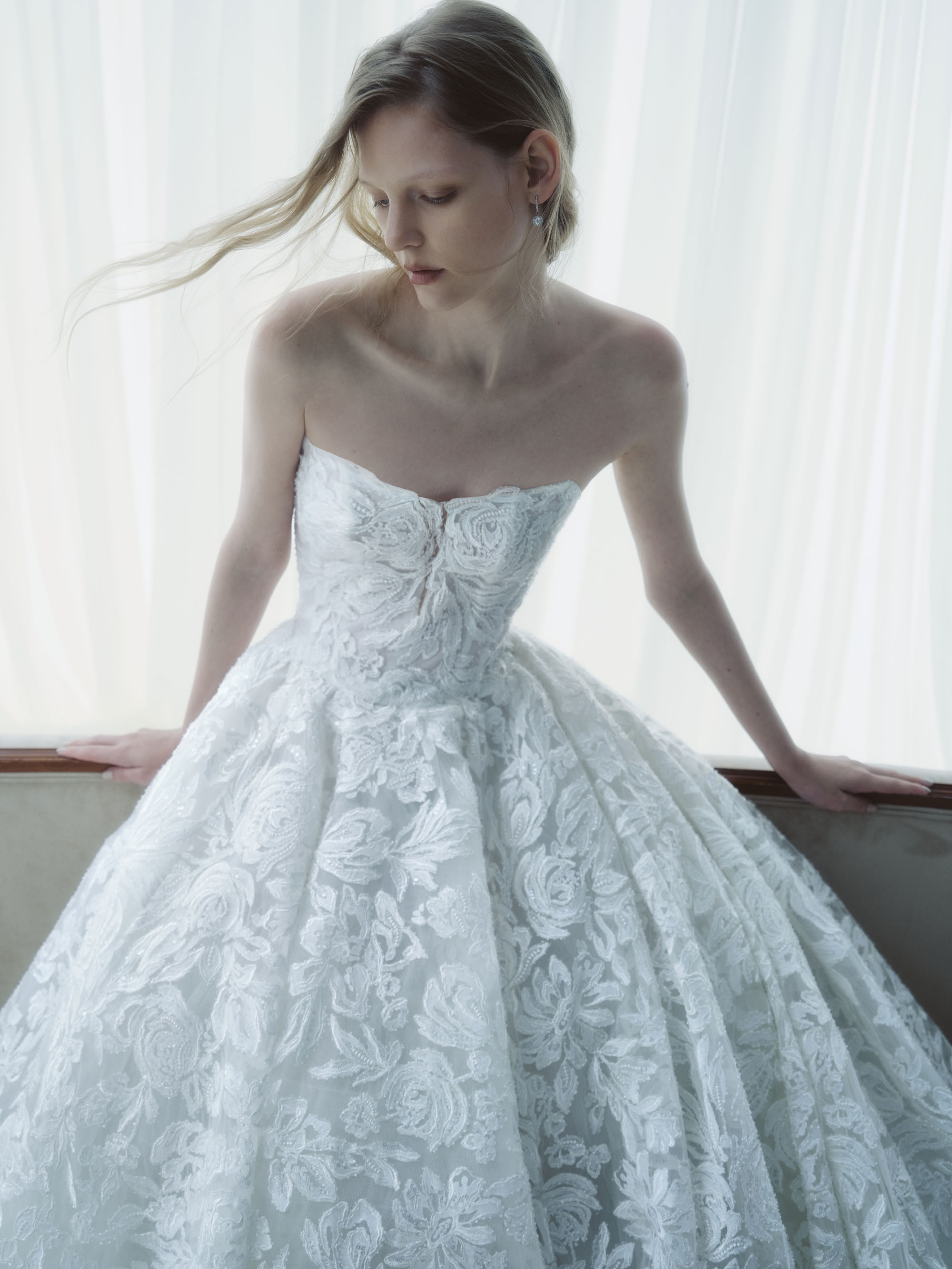 Breathe RIVINI FW26 strapless cat-eye ball gown in beaded laser-cut floral lace, shown close up from the front.
