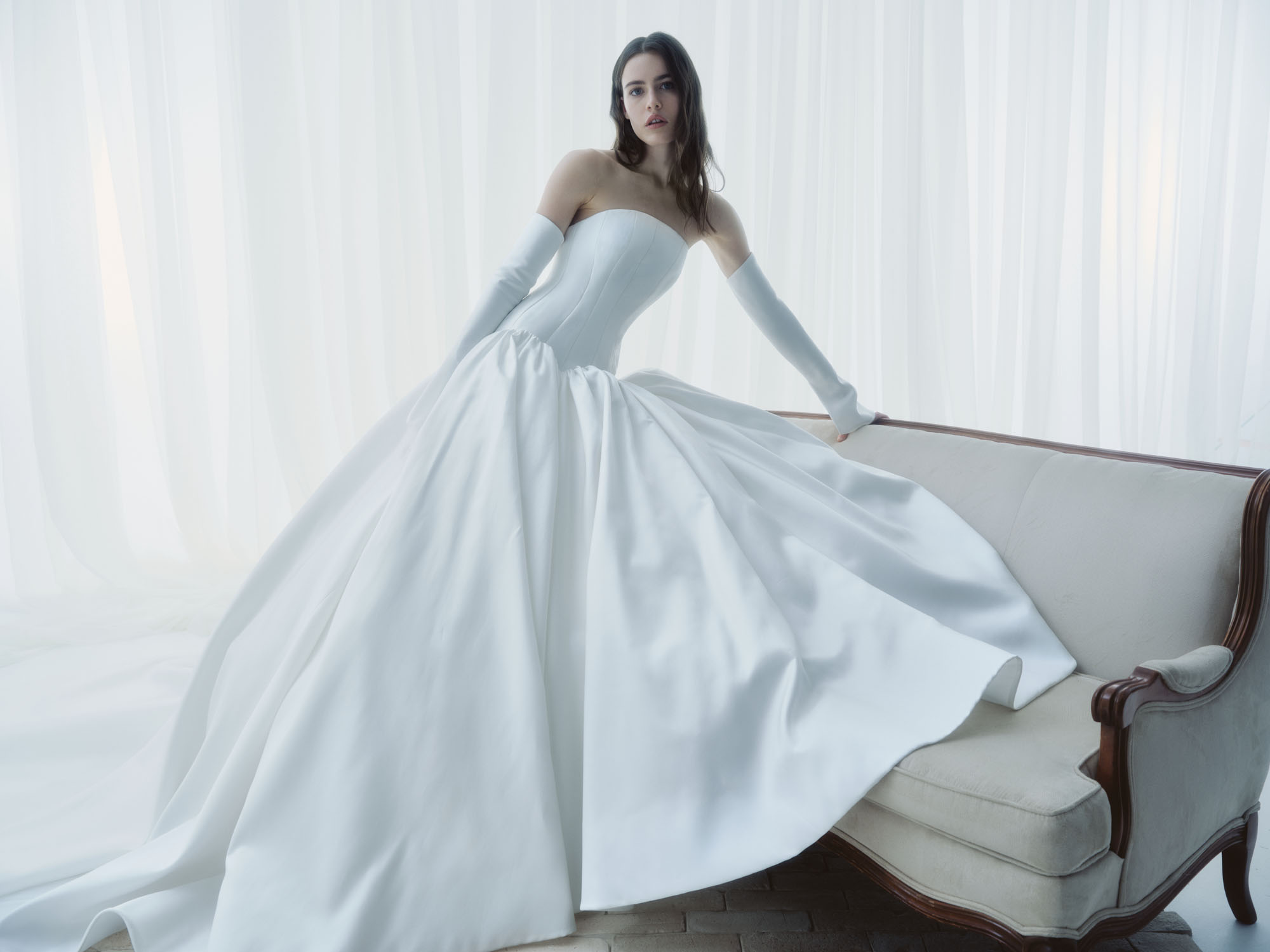 Cascade RIVINI FW26 grand silk ball gown with elongated drop waist, sculpted strapless bodice, and voluminous gathered skirt, shown in motion.