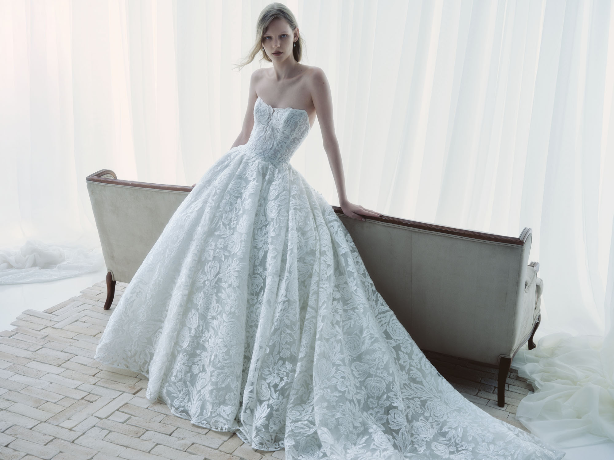 Full front view of Breathe showing the structured cat-eye bodice, intricate floral lace, and voluminous skirt.