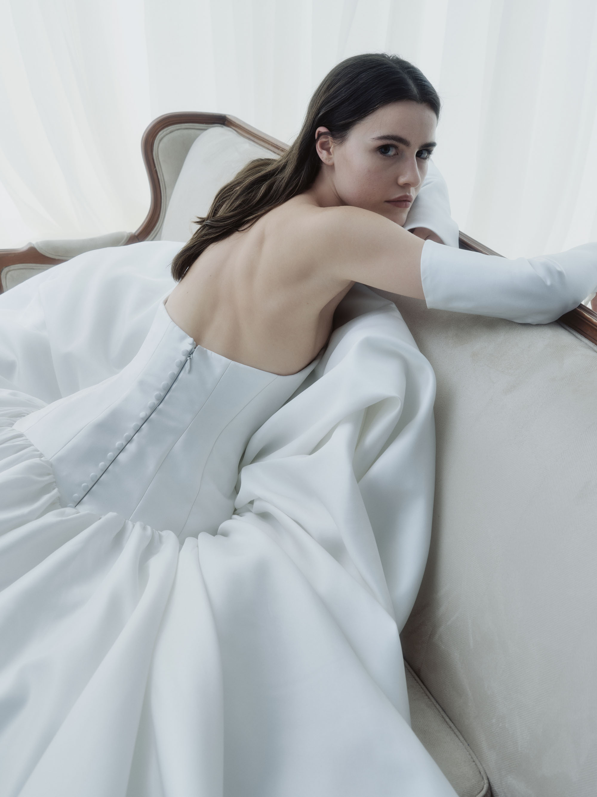 Close-up of Cascade showing the sculpted strapless bodice, elongated drop waist, and flared glovelettes.