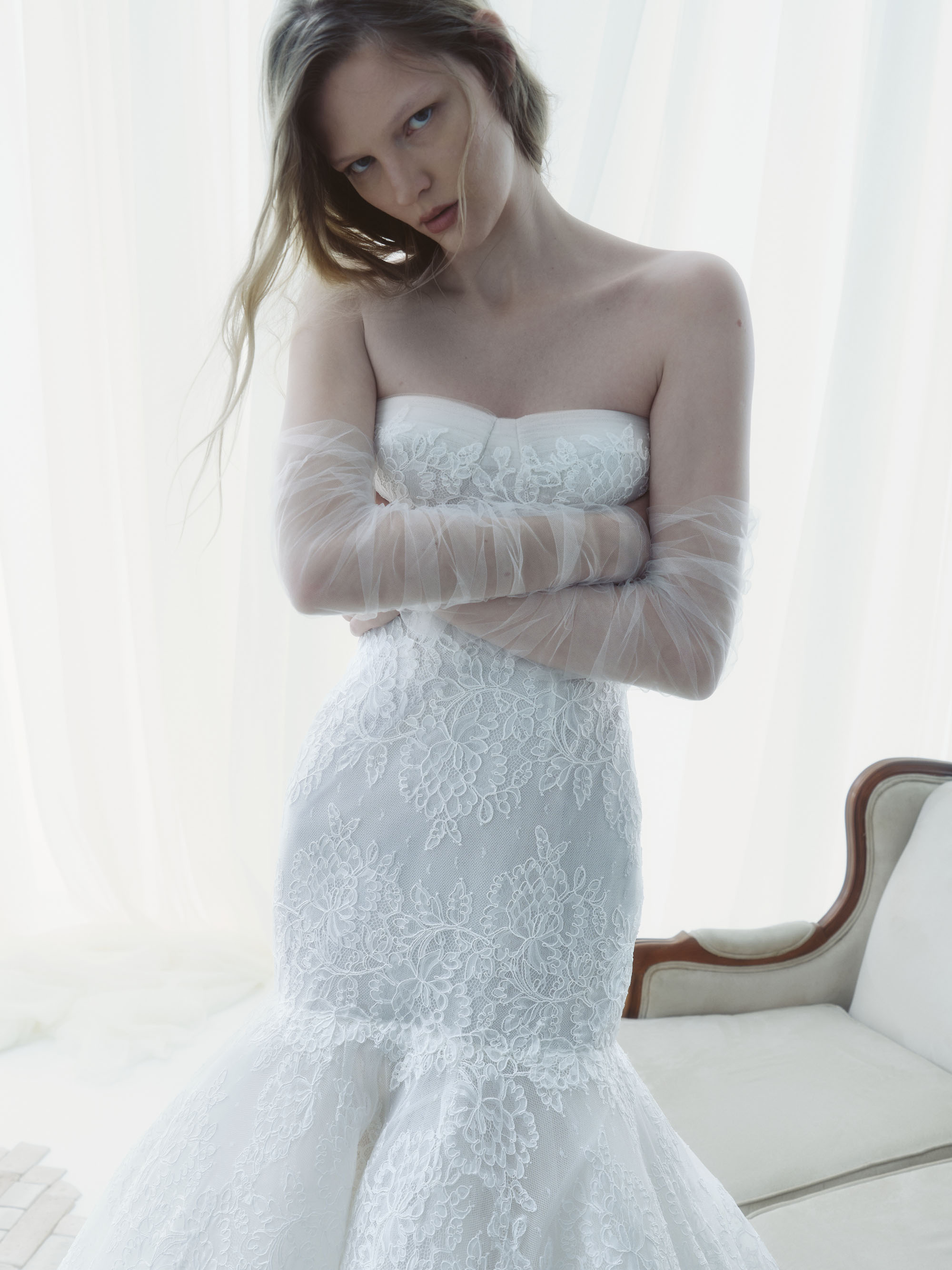 Horizon RIVINI FW26 strapless Chantilly corded lace gown with an elongated sculpted bodice and dramatic flared skirt, shown from the front.