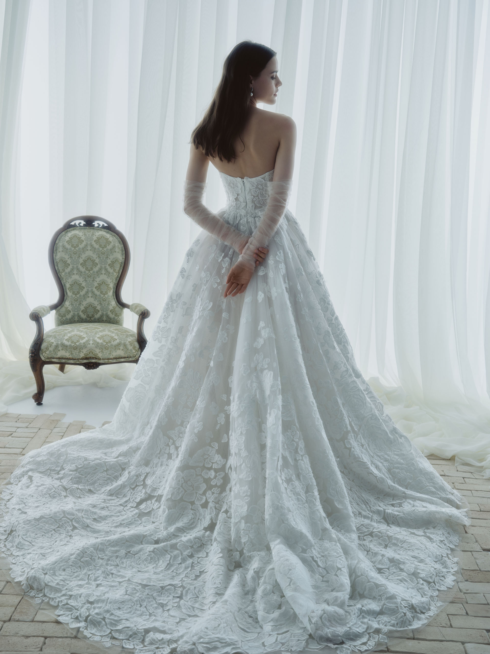 Back view of Mist showing the fitted strapless bodice and sweeping floral lace train.