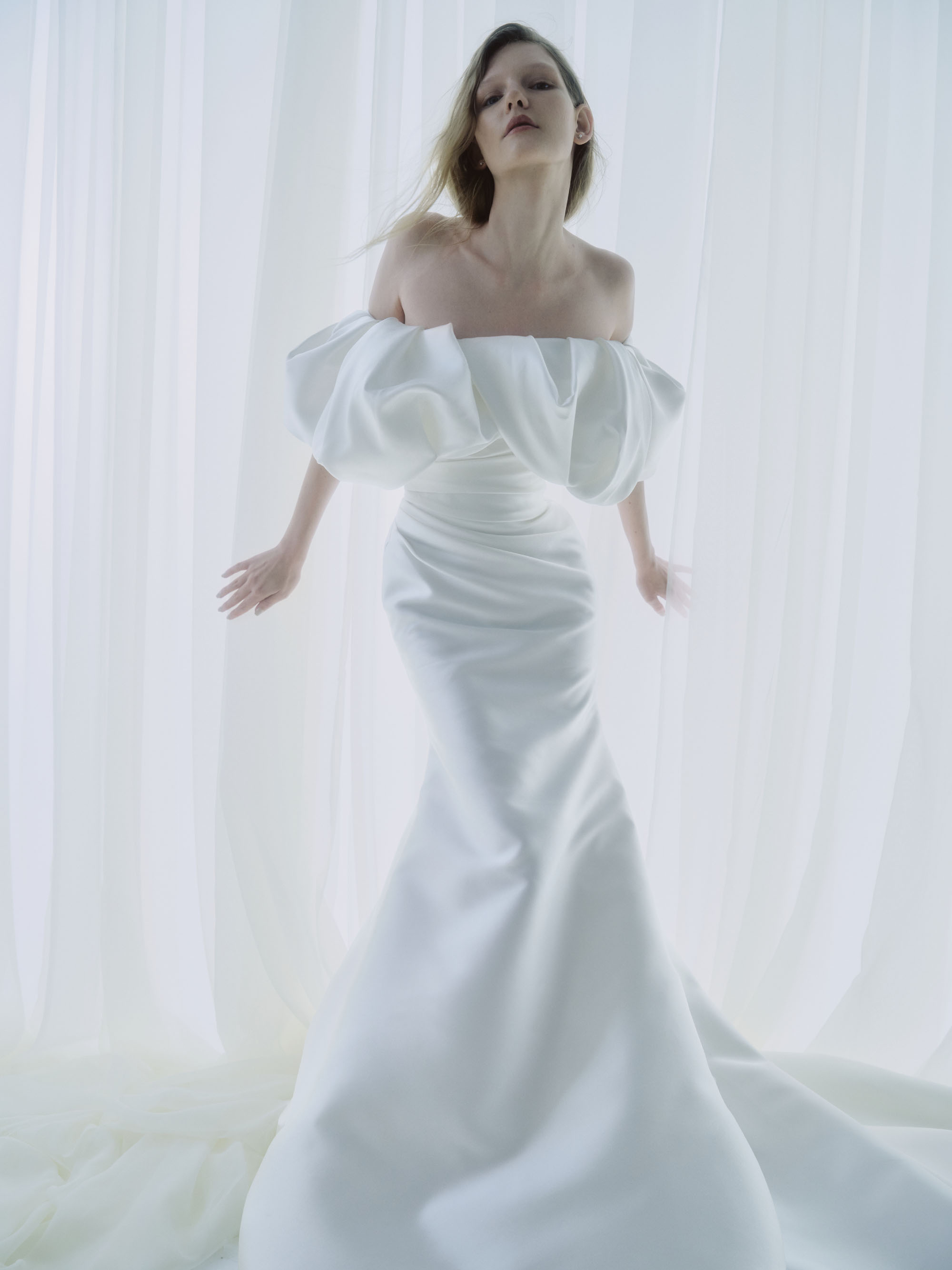 Poise RIVINI FW26 strapless silk fit-and-flare gown with an elongated silhouette and detachable off-the-shoulder portrait shawl, shown from the front.