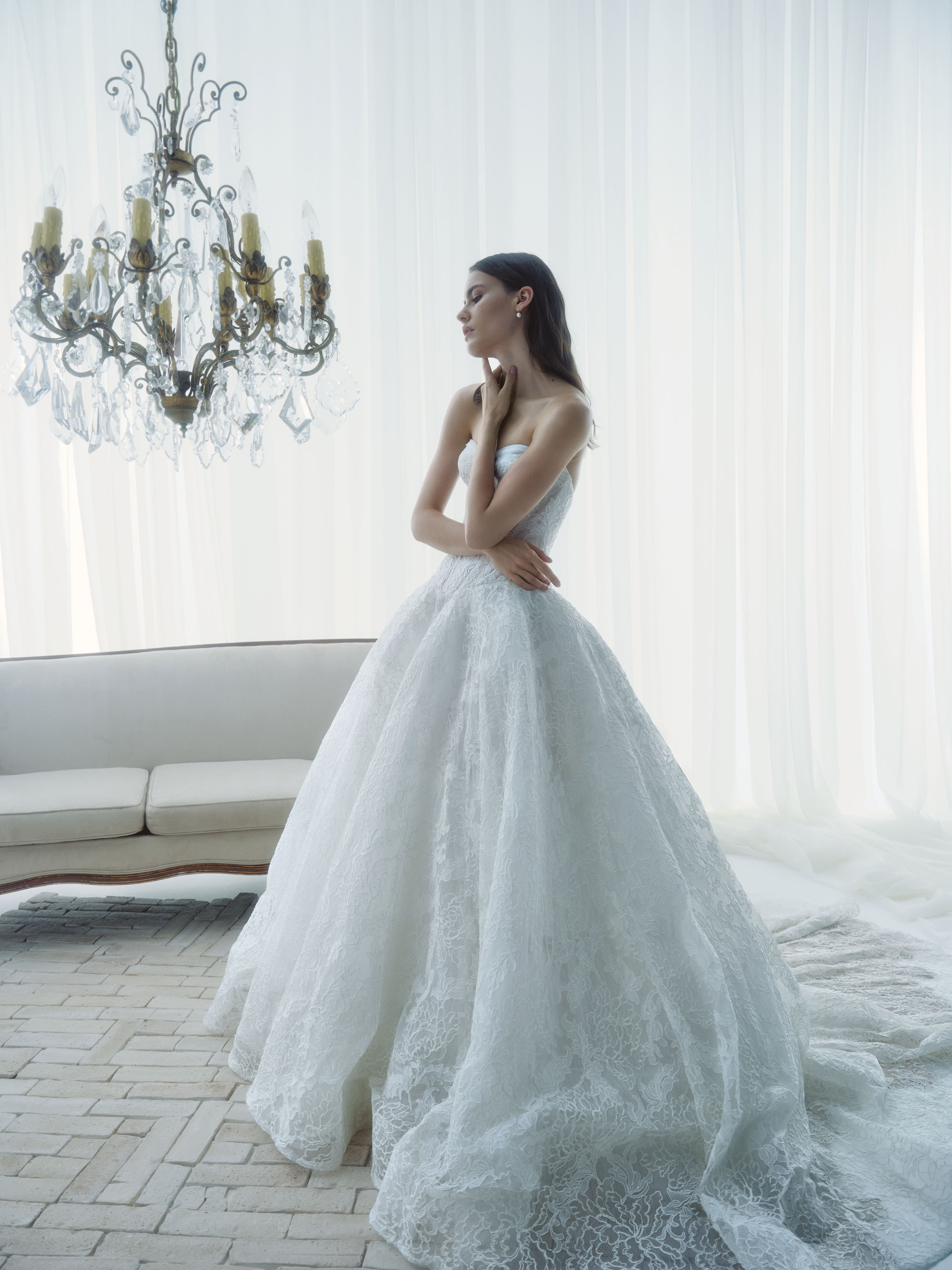 Front view of Radiance showing the deep V-neck corset, hand-appliquéd lace, and voluminous Chantilly lace skirt.